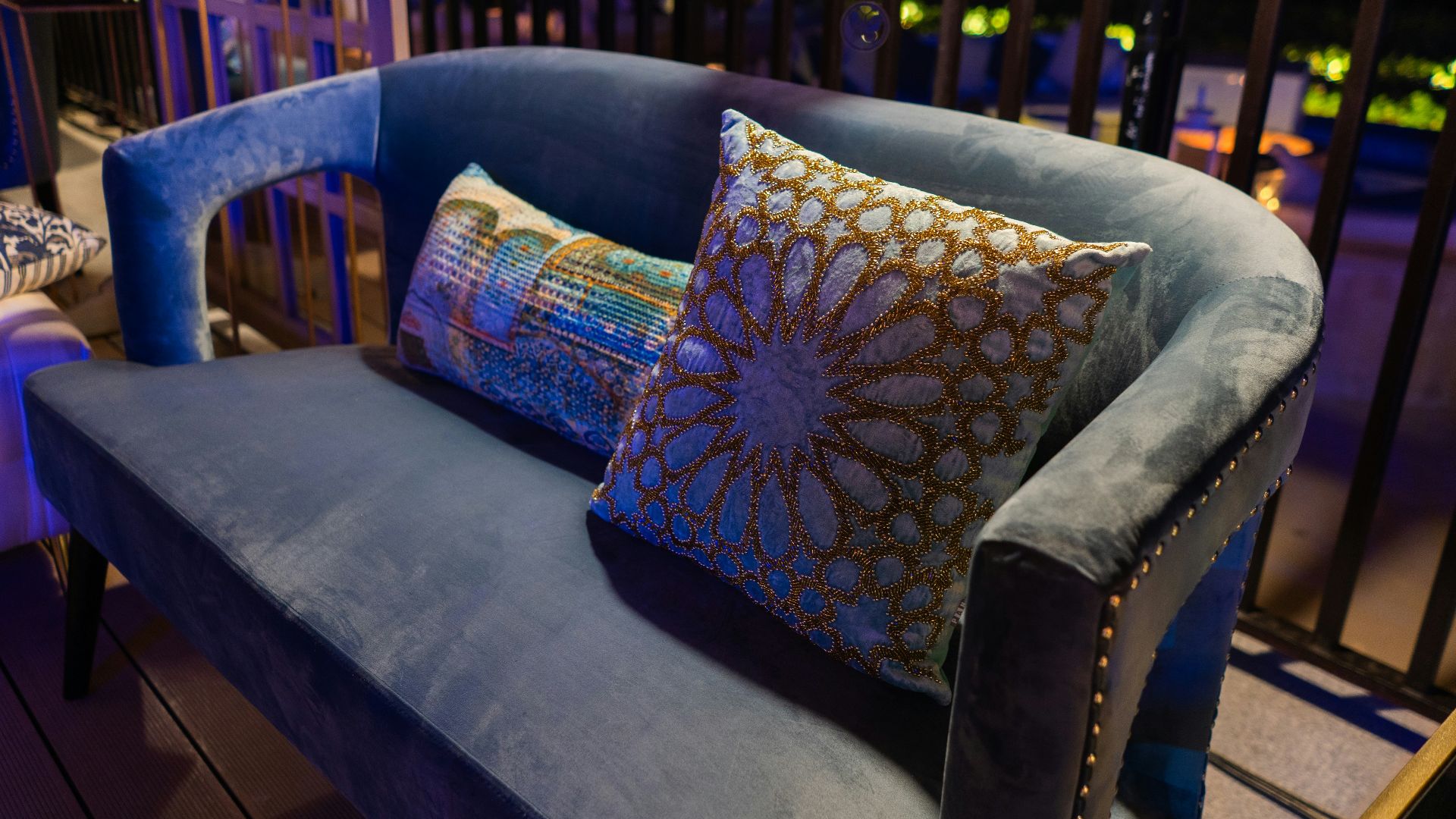 A cozy blue couch with decorative pillows.