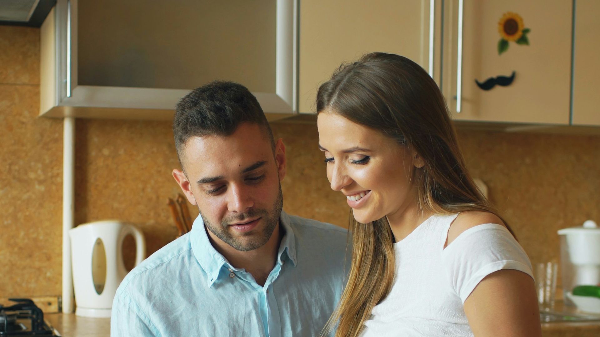 Couple looking at tablet in modern kitchen