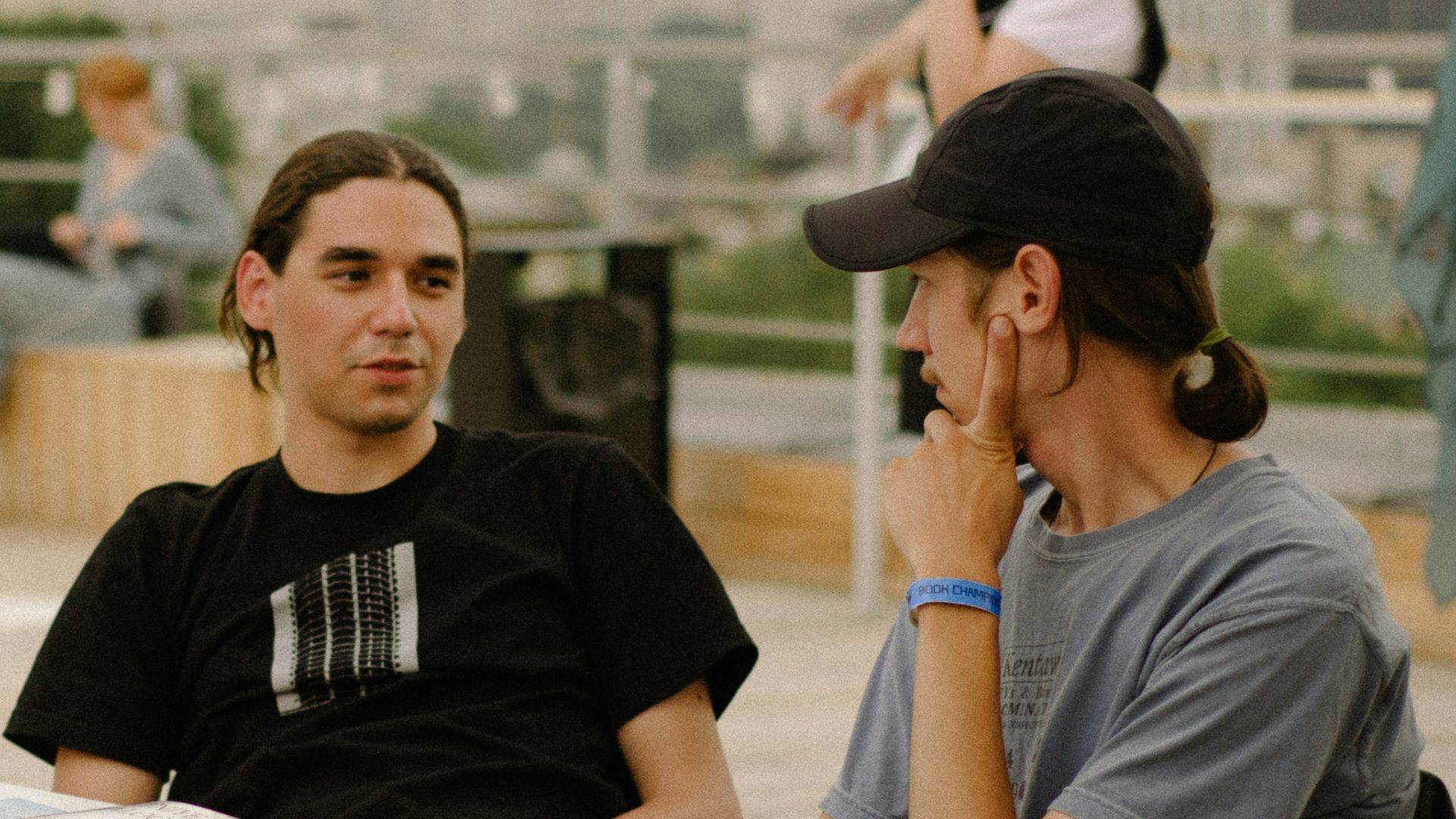 a man sitting at a table talking on a cell phone