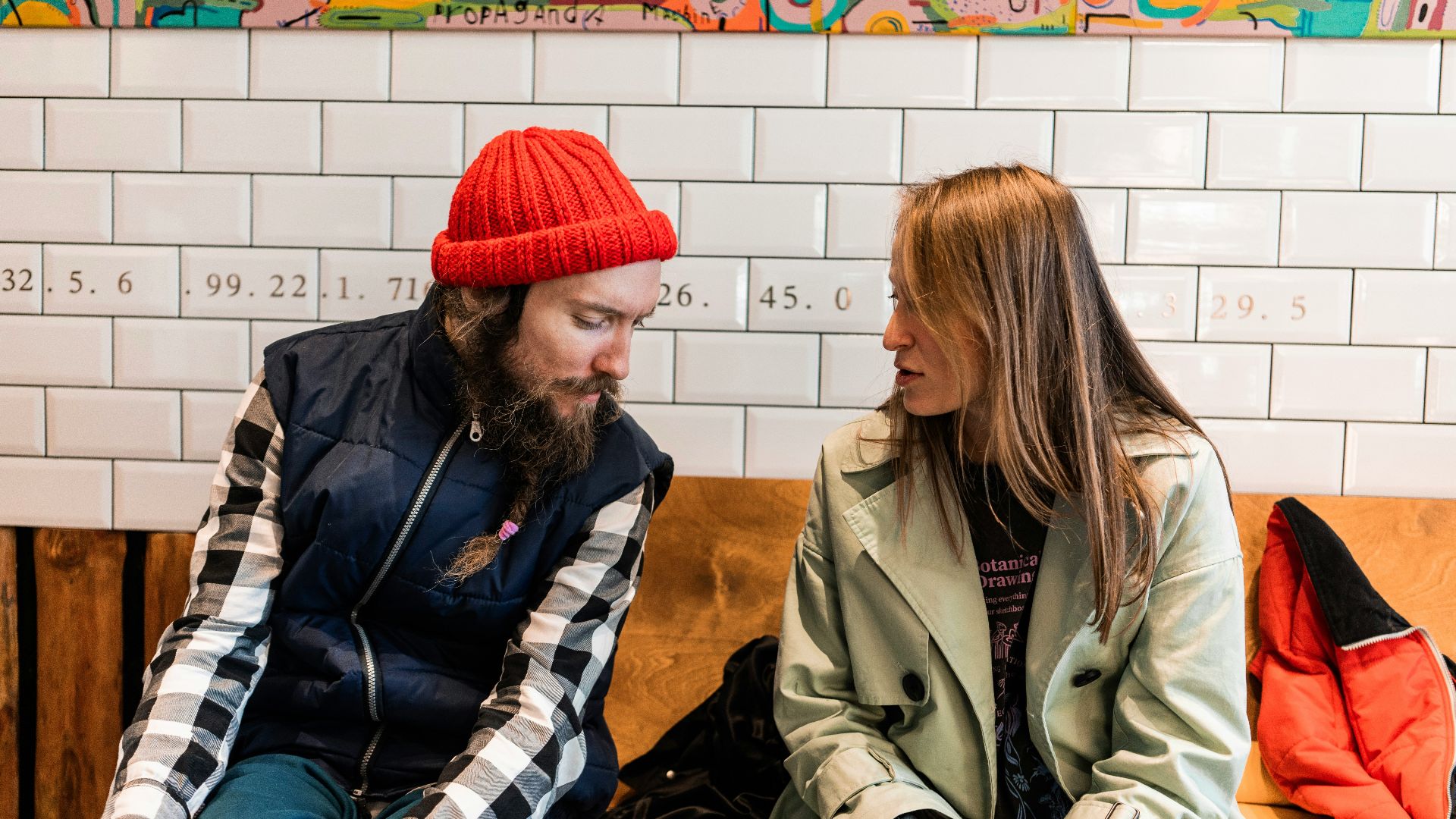 a man and a woman sitting on a bench