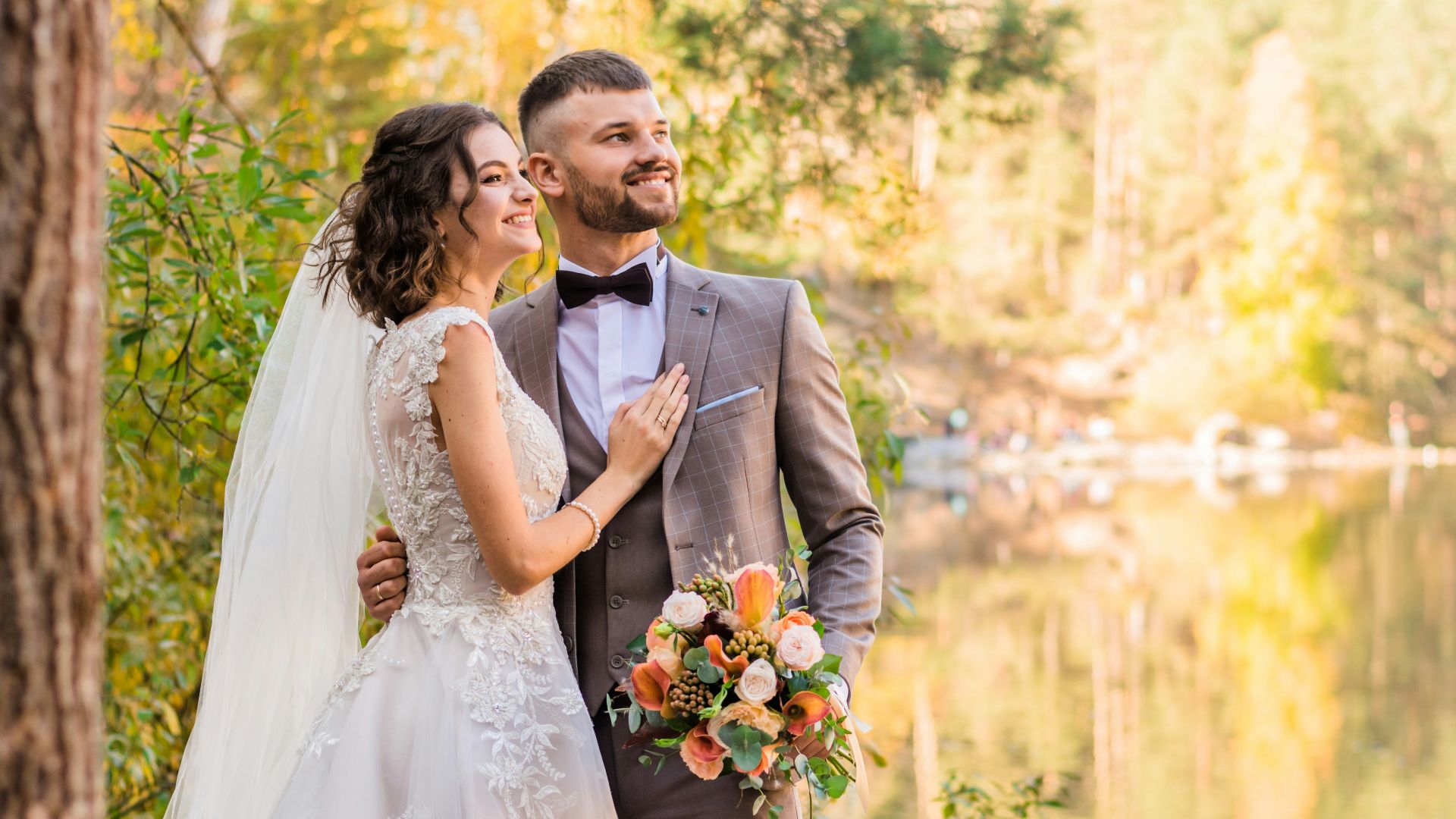 man in gray suit and woman in white wedding dress