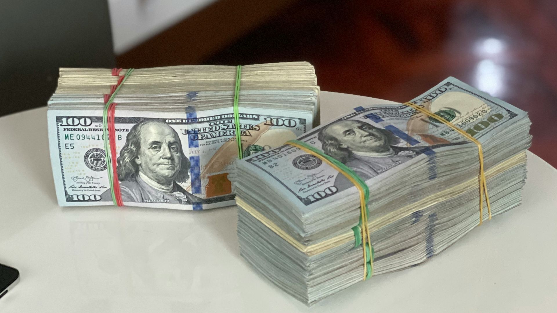 a stack of money sitting on top of a white table