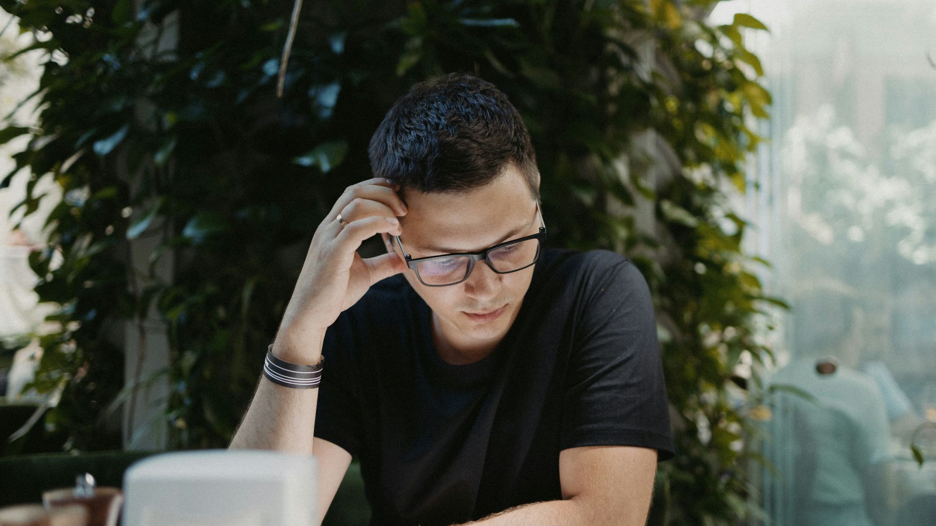 man in black crew neck t-shirt wearing black framed eyeglasses