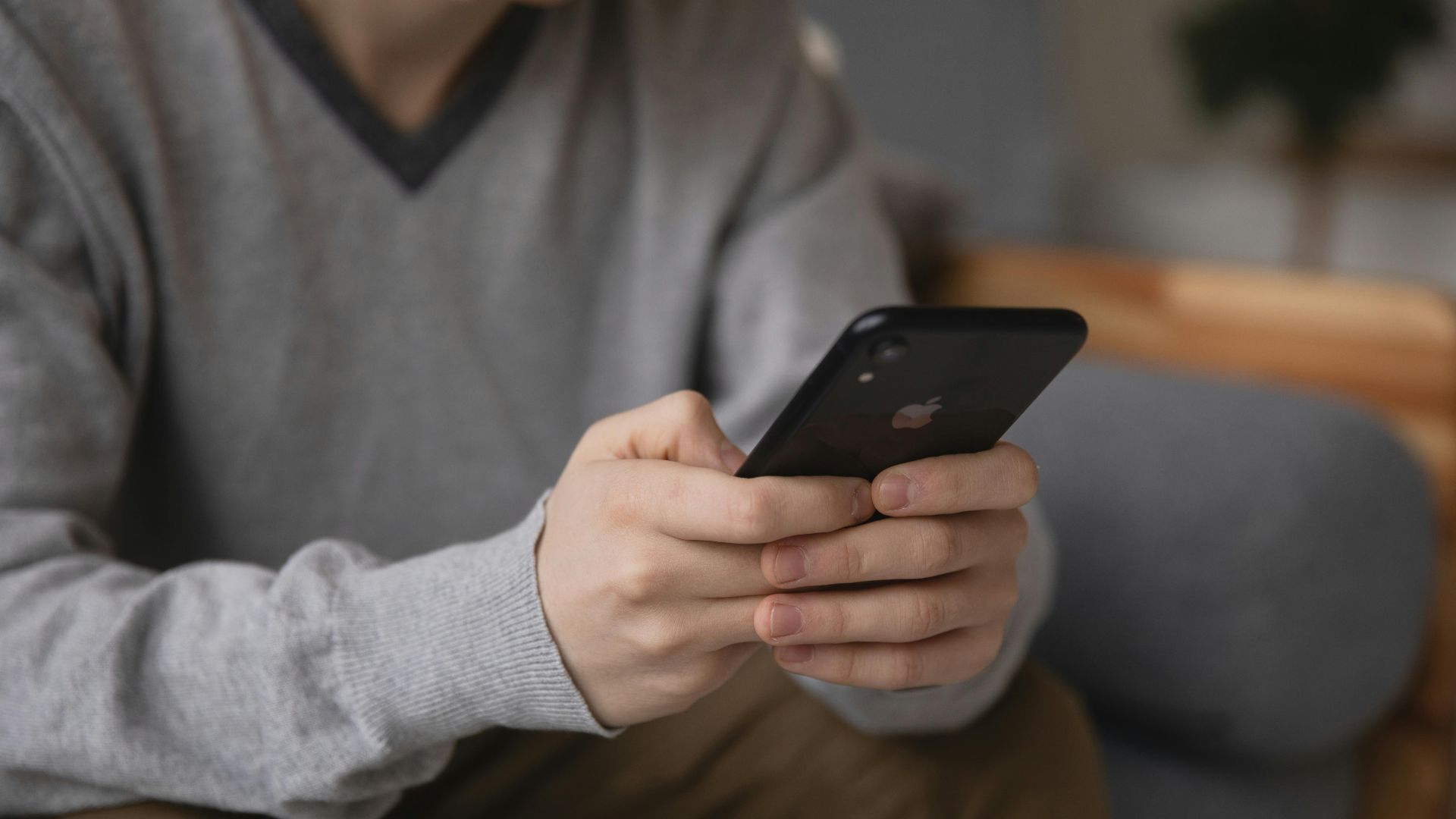 Person holding a smartphone, focusing on connectivity and modern technology.