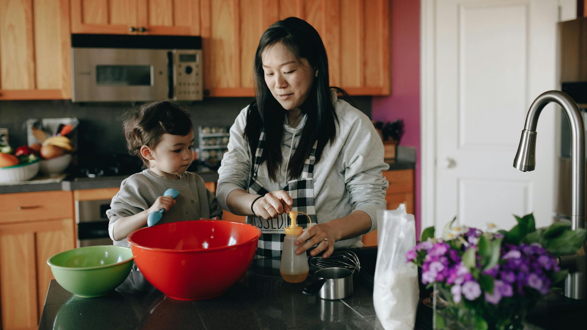 Heartwarming scene of a mother and child baking together in a cozy home kitchen.