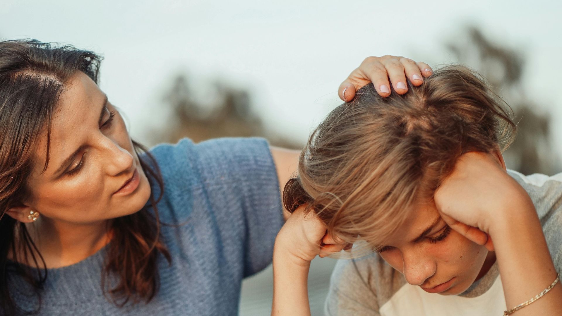 A mother offers support to her discouraged teenager son, portraying love and understanding.