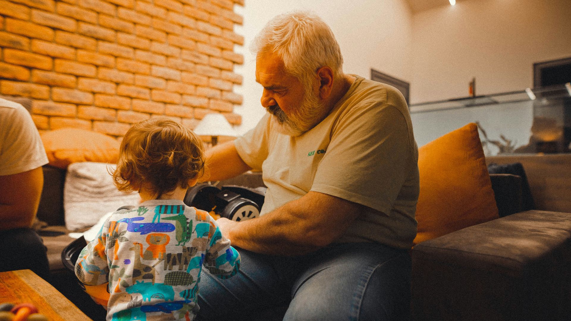 a man sitting on a couch with a child