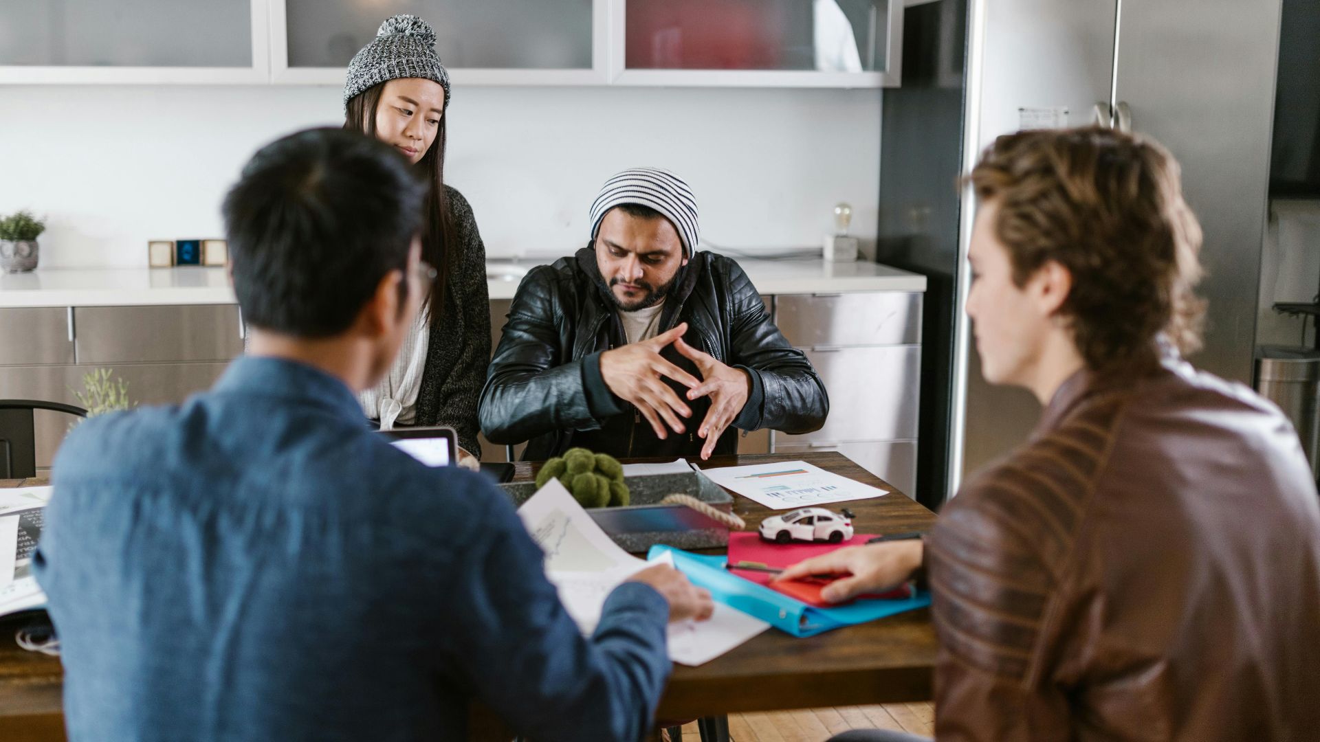 A group of diverse colleagues in a modern office setting engaged in a brainstorming session.