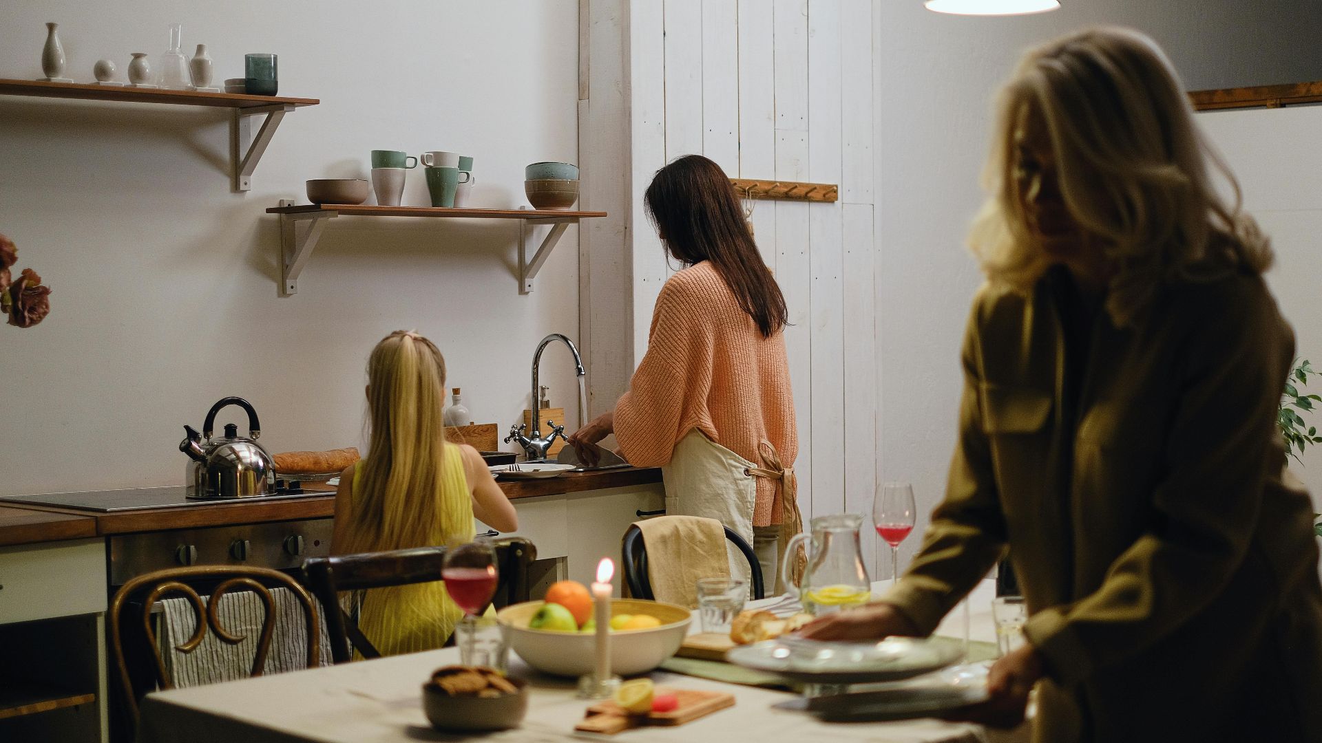 A family preparing meals in a cozy kitchen setting, emphasizing bonding and domestic life.