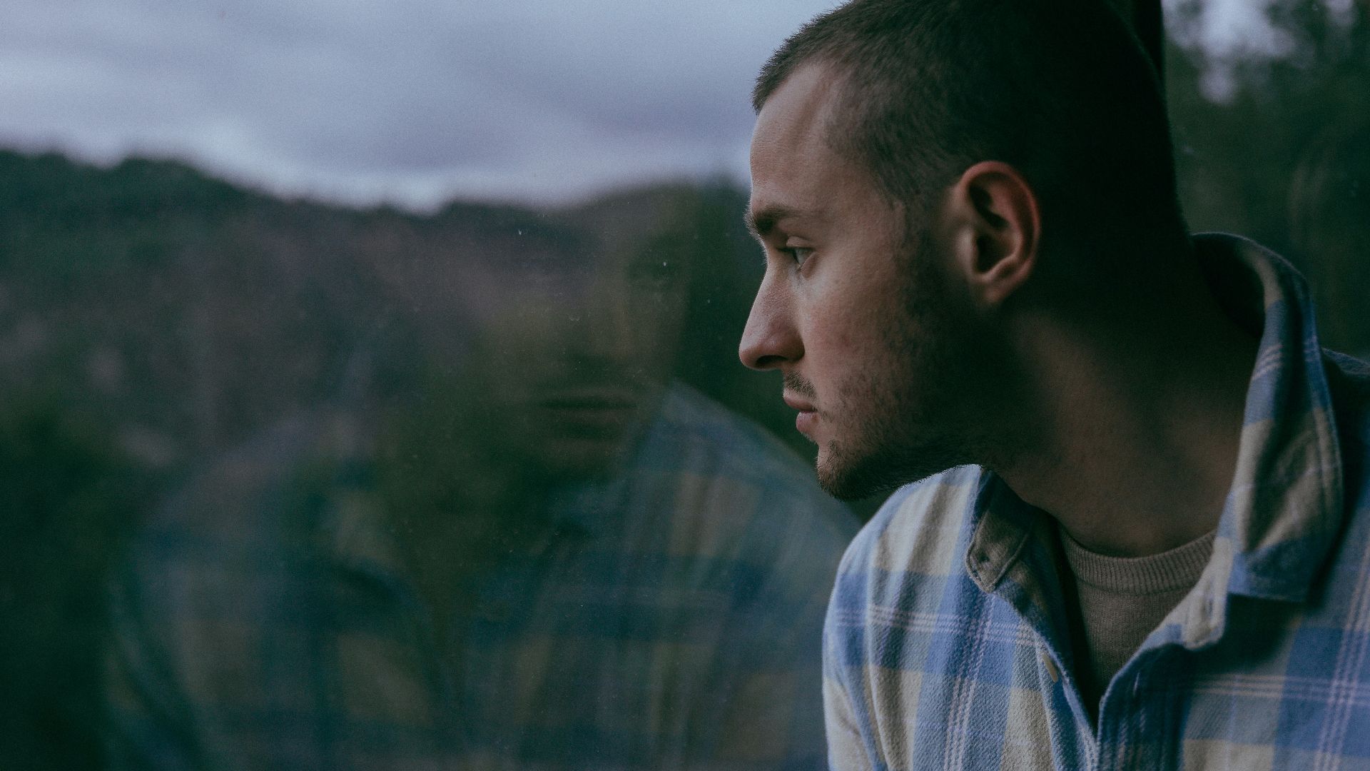 a man looking out of a train window