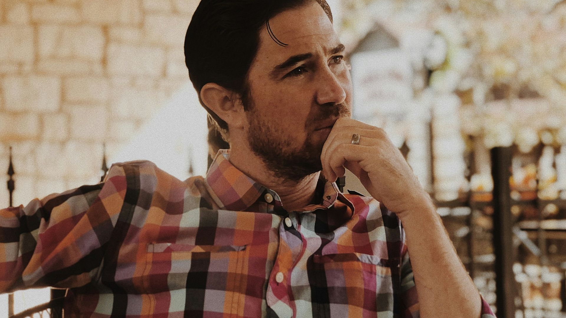 man in red and black plaid dress shirt