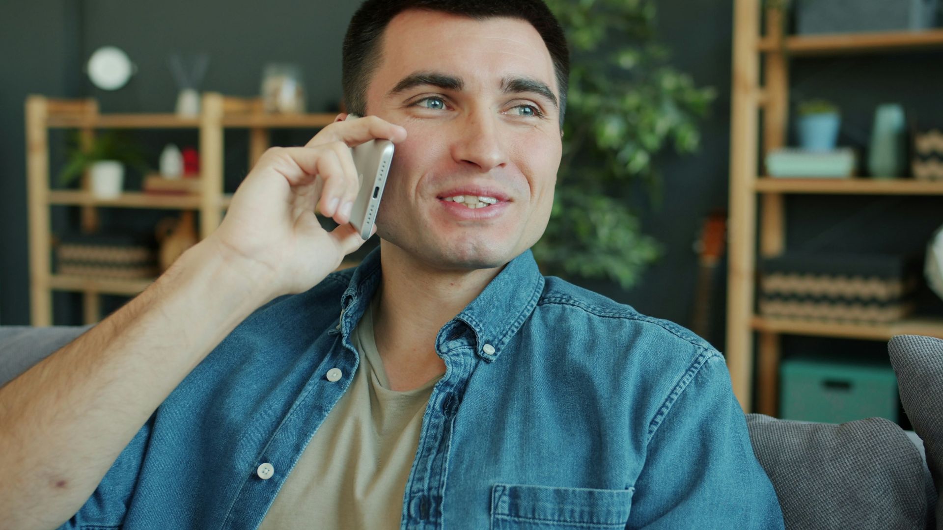 Man talking on a smartphone at home