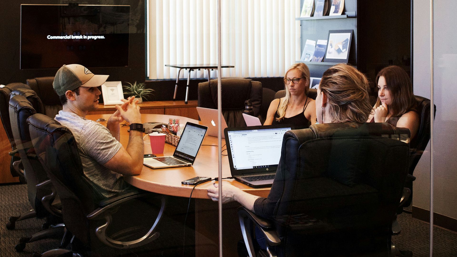 people sitting near table with laptop computer