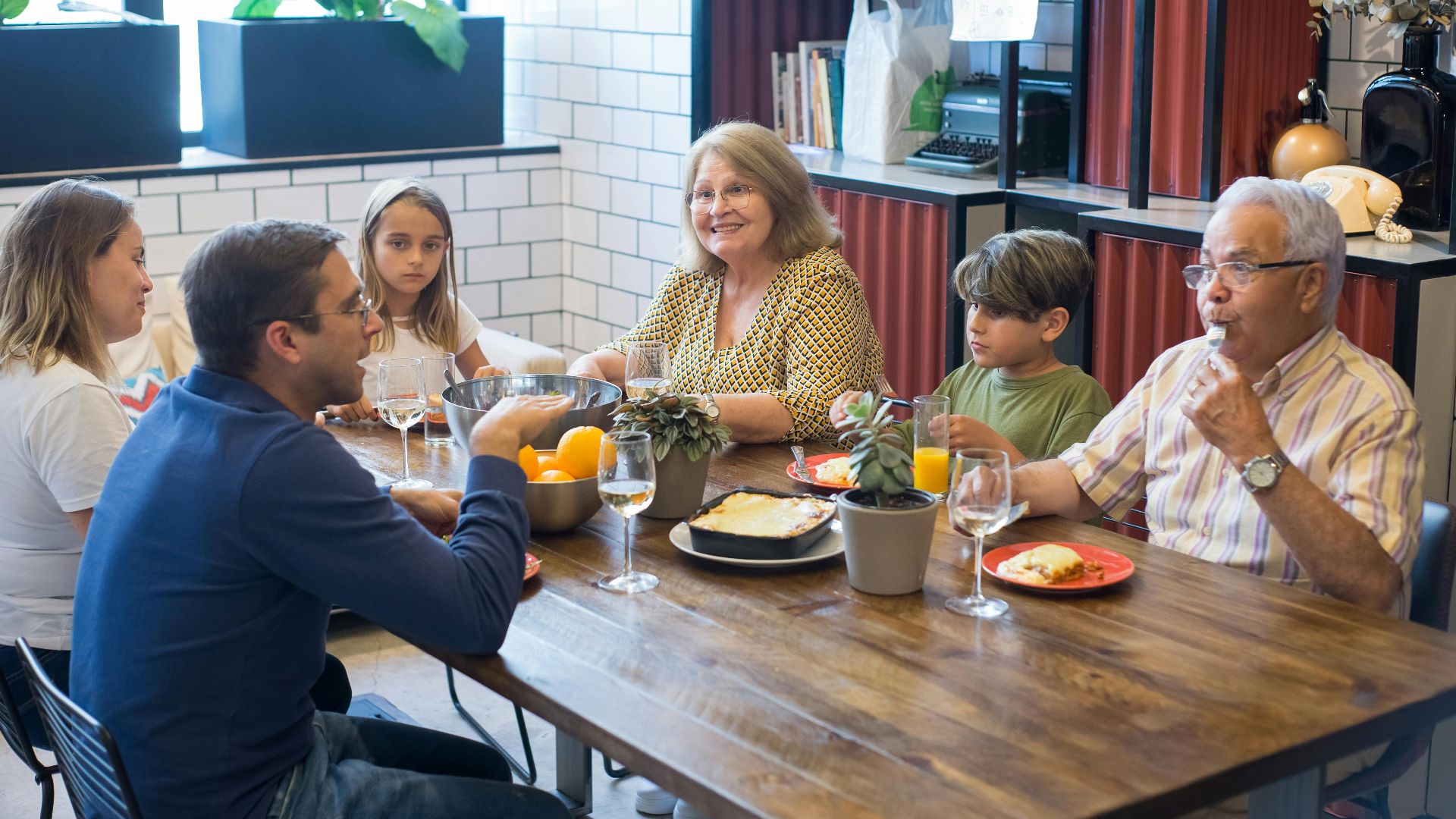 A joyful family dining together indoors, highlighting togetherness and culinary enjoyment.