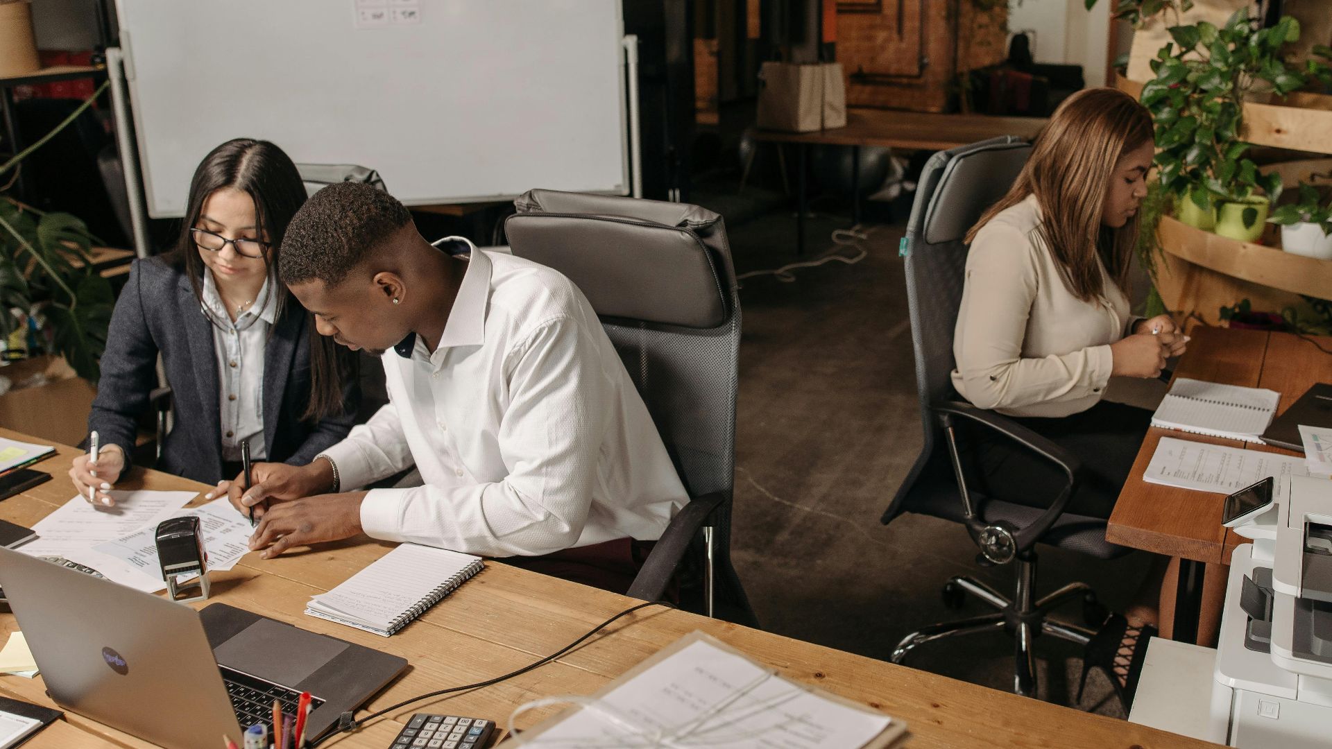 Teamwork in a modern office with diverse colleagues working together on documents.