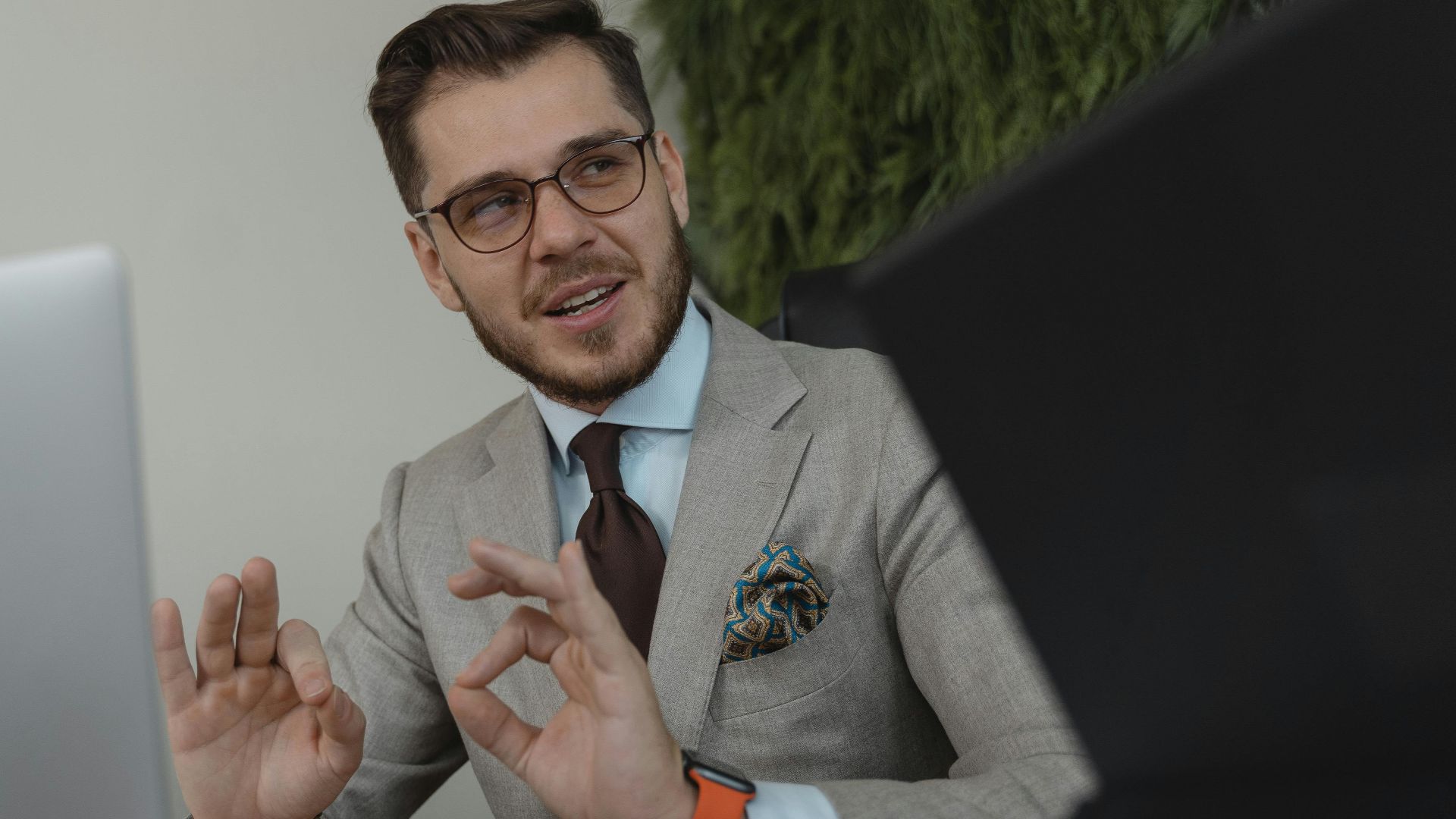 Professional businessman engaging in a discussion at his workplace, conveying confidence and leadership.
