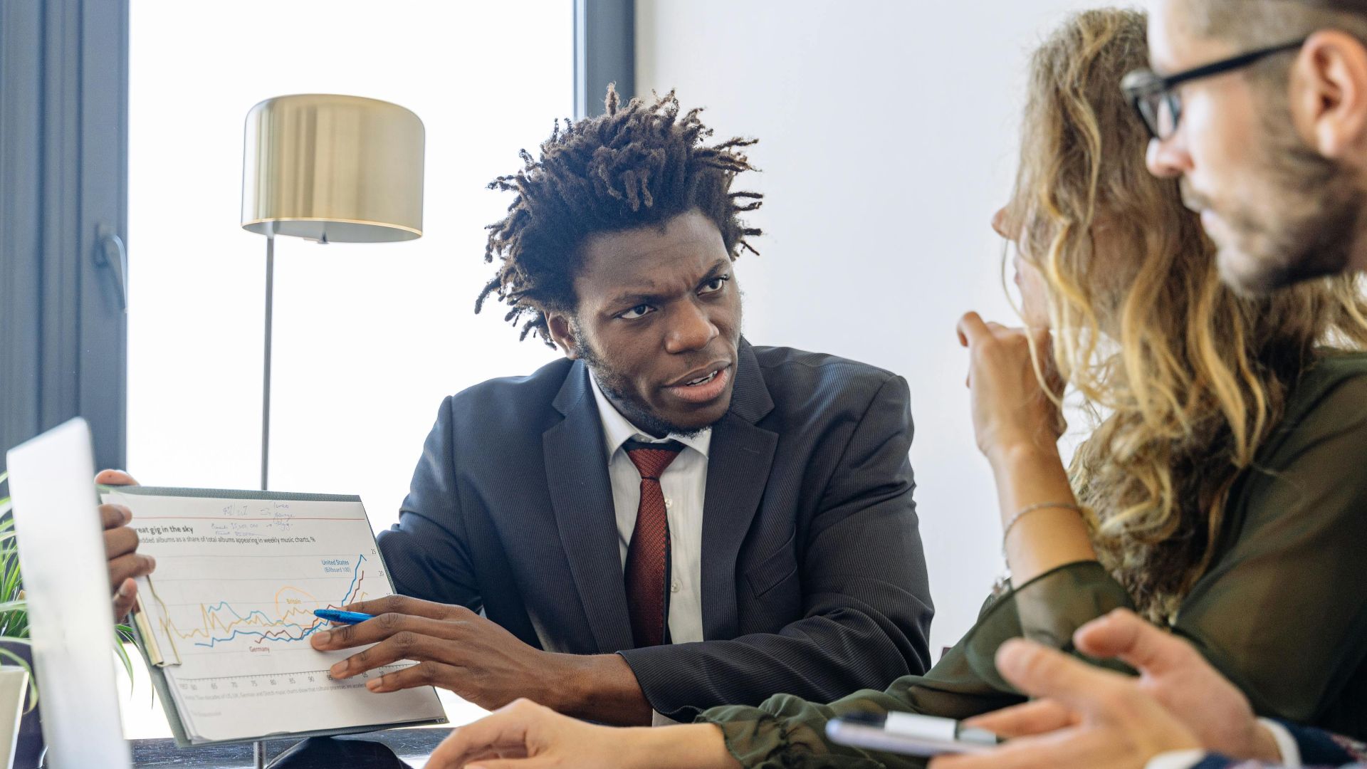 Business professionals discussing financial data during a collaborative meeting.