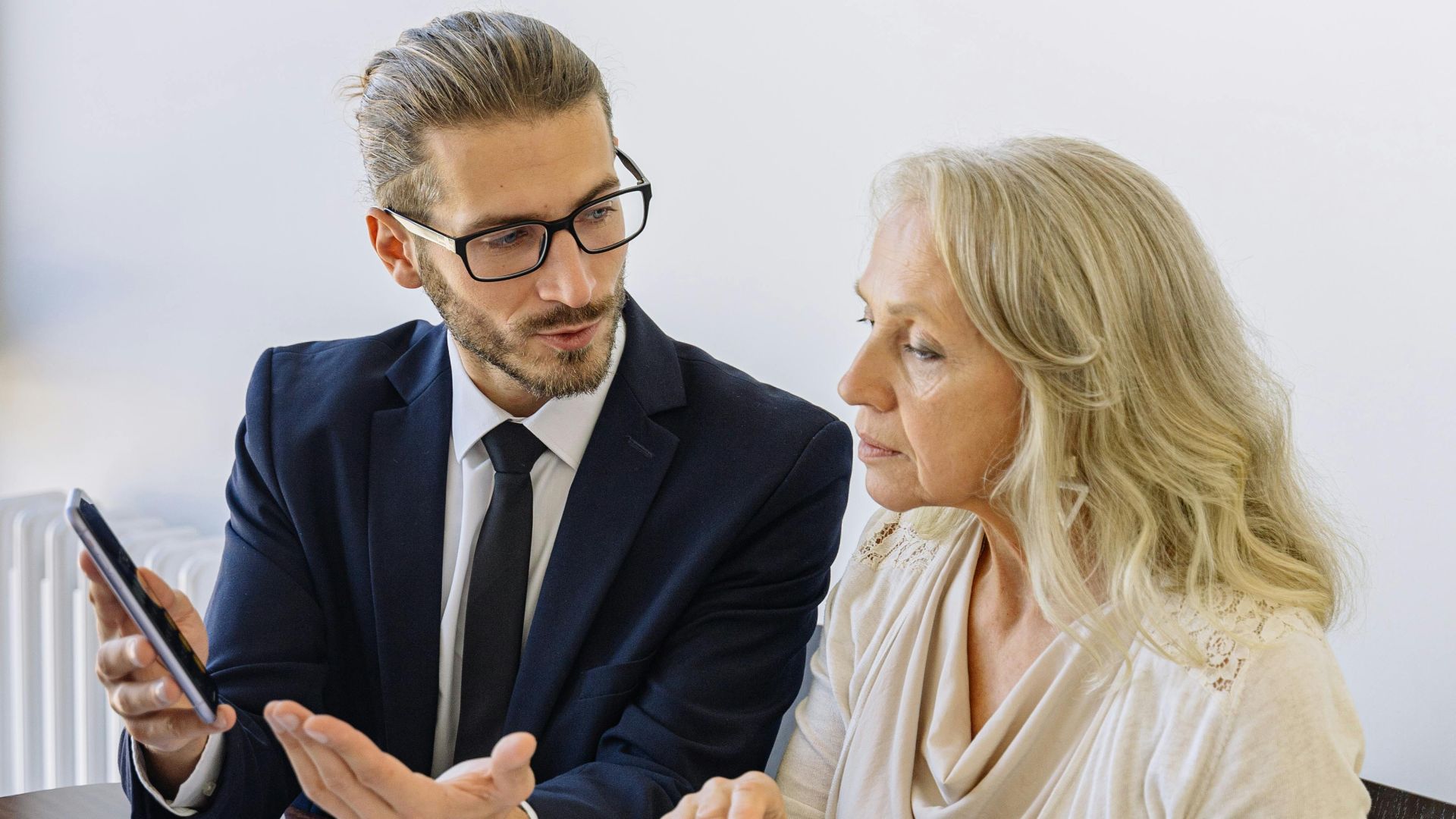 Professional business discussion between a consultant and client in an office setting.