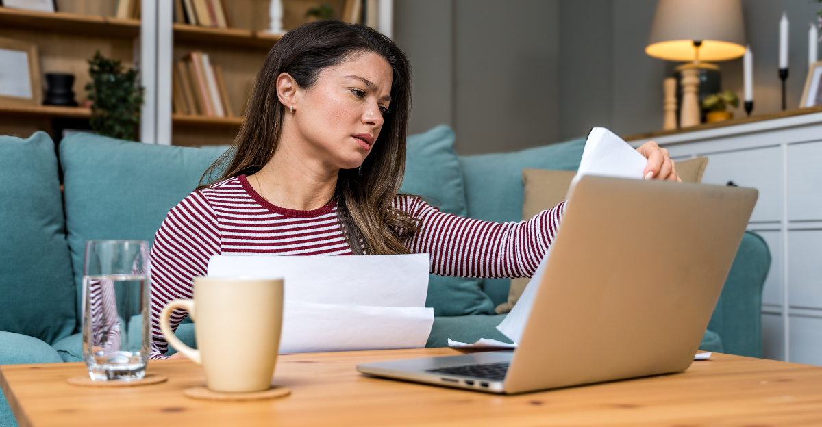 Financial crisis. Young worried businesswoman sitting at home