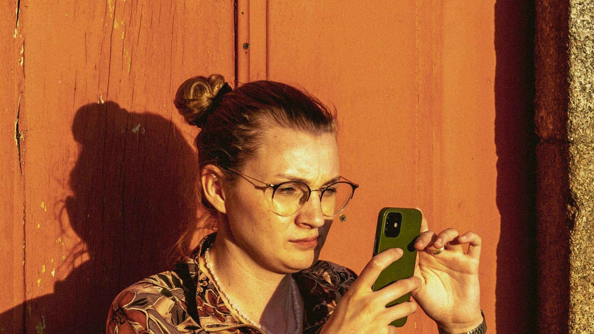 Woman sitting outside using her phone