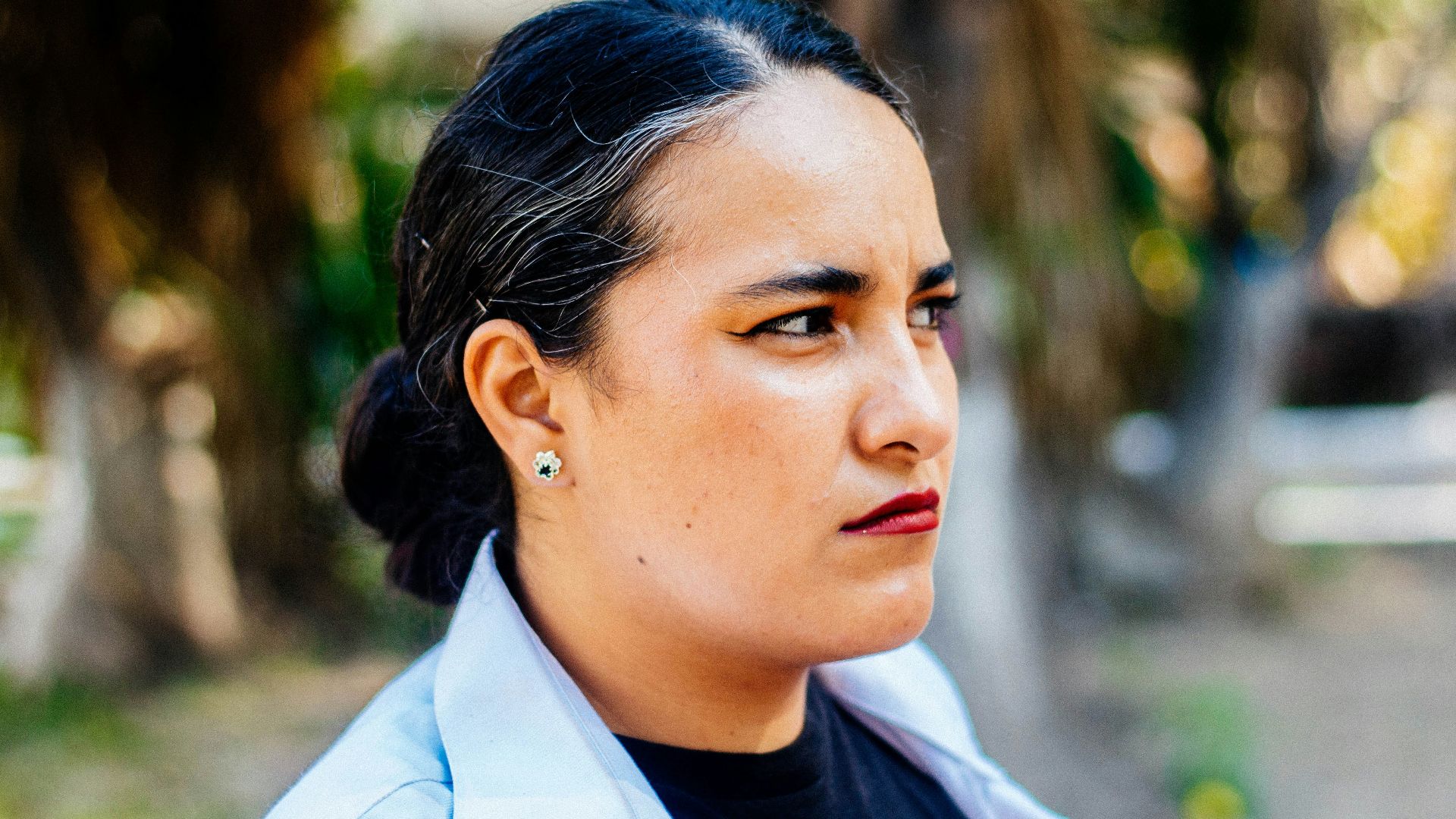 a woman in a black shirt and a white blazer