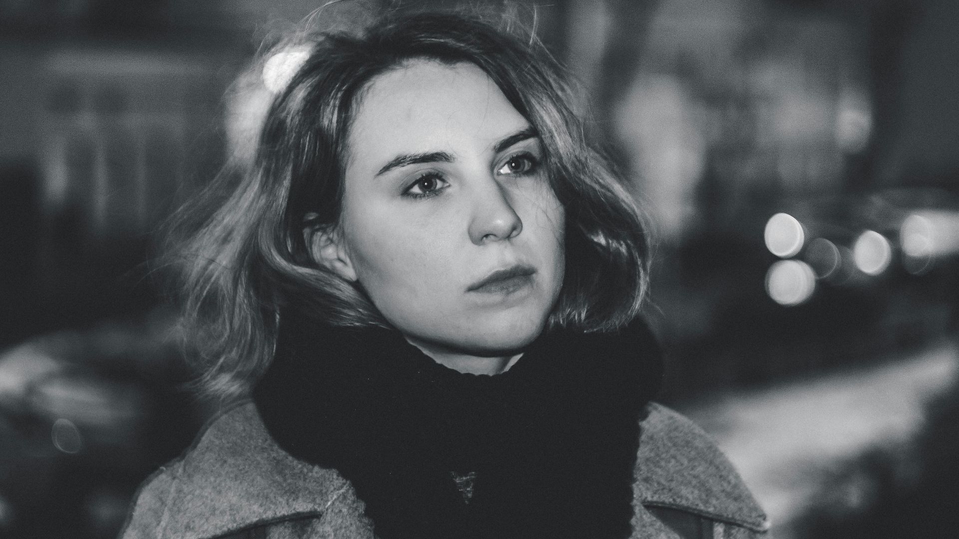 Captivating black and white portrait of a woman with a thoughtful expression.