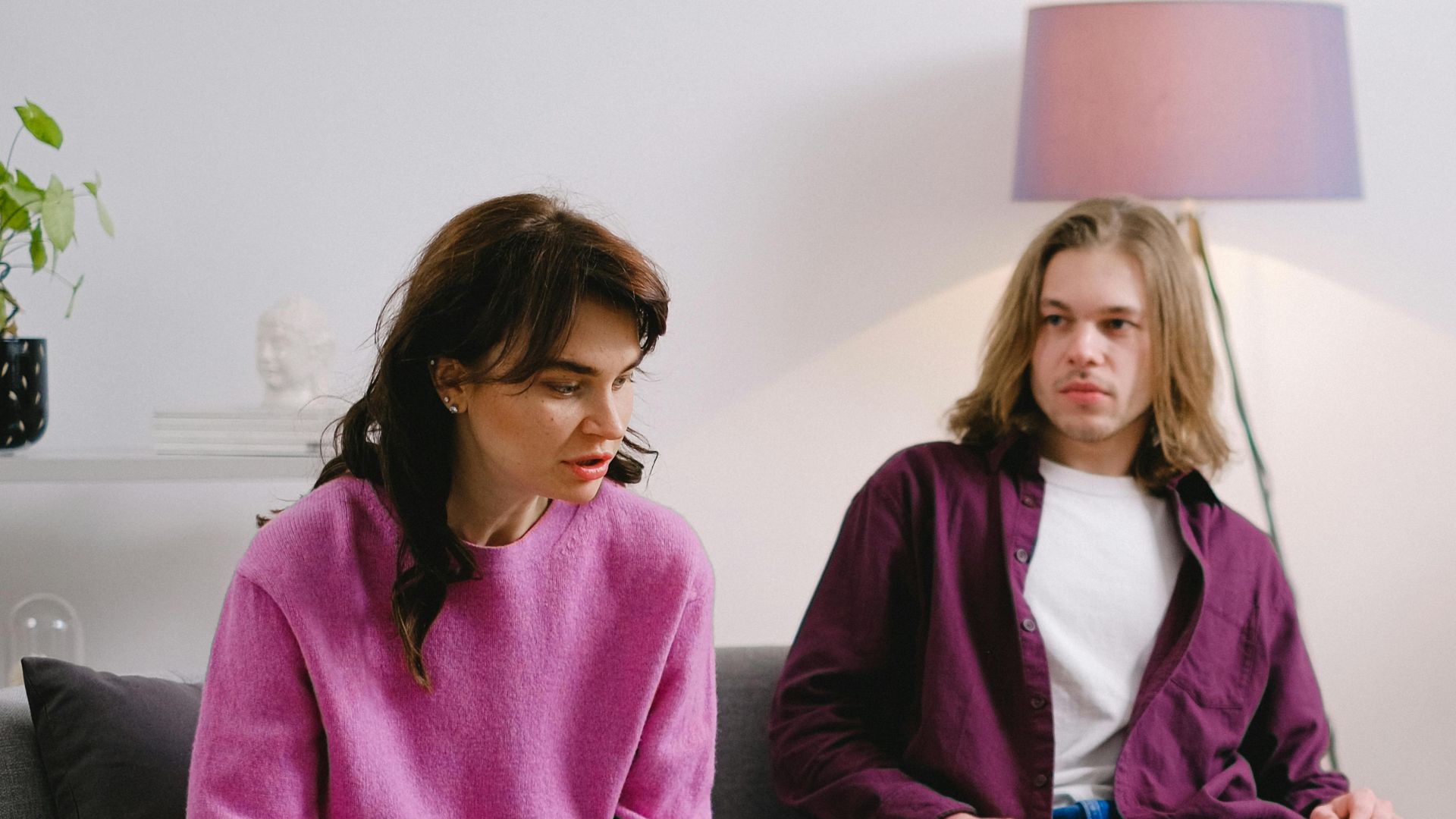 A family participates in a psychotherapy session in a cozy living room setting.