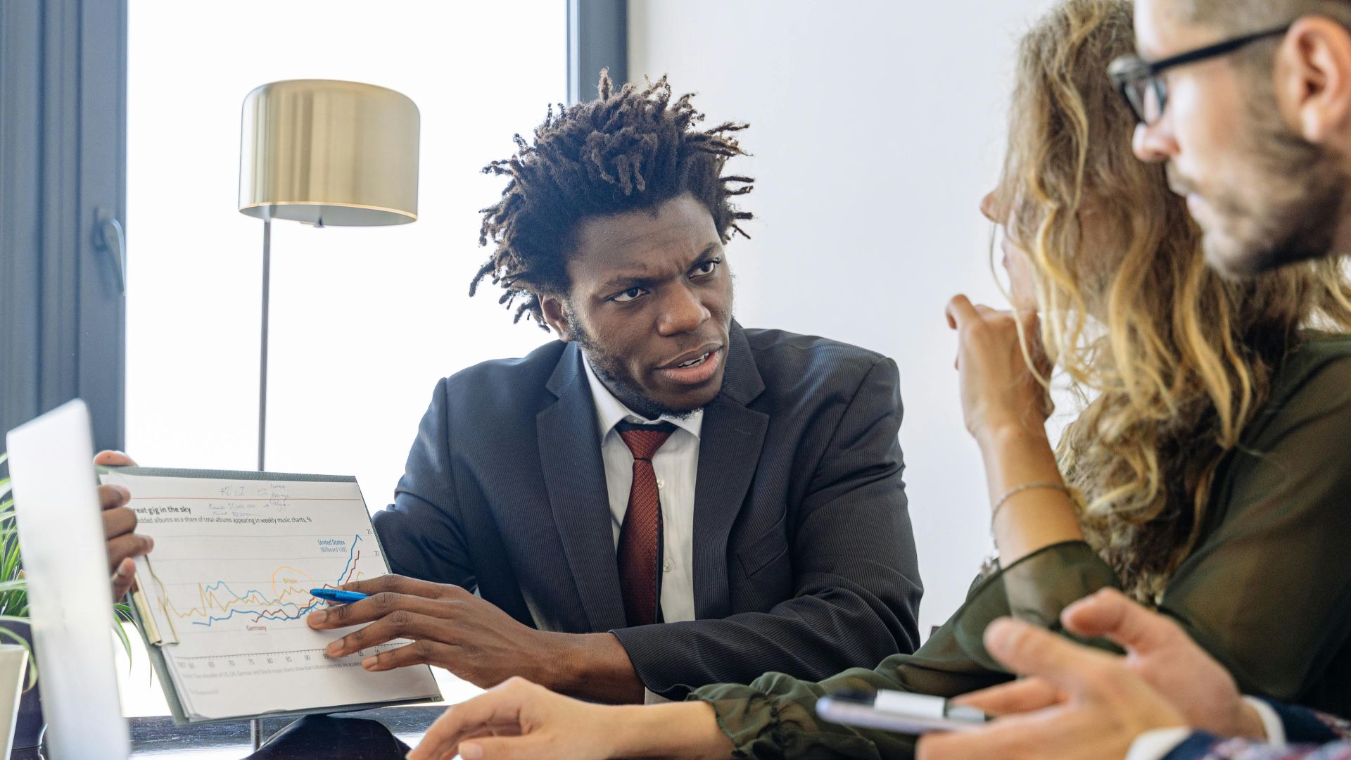 Business professionals discussing financial data during a collaborative meeting.