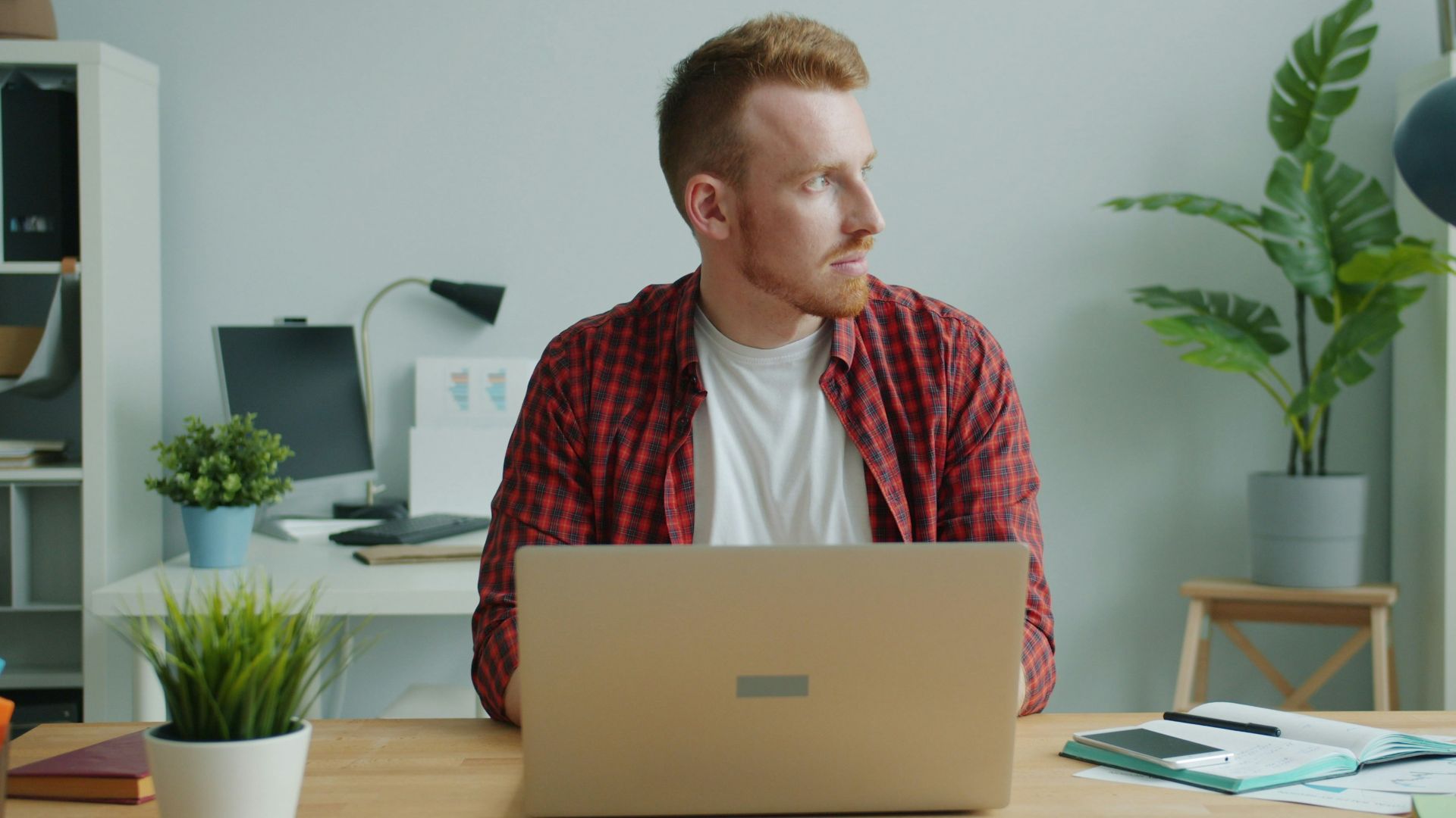 Man working on laptop at desk in office