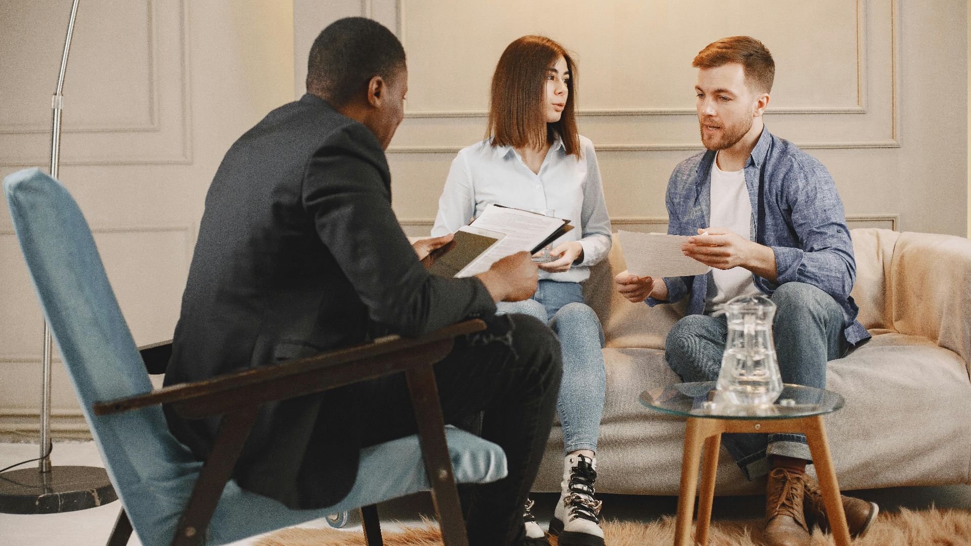 A counseling session with a diverse group of adults discussing issues in a cozy setting.