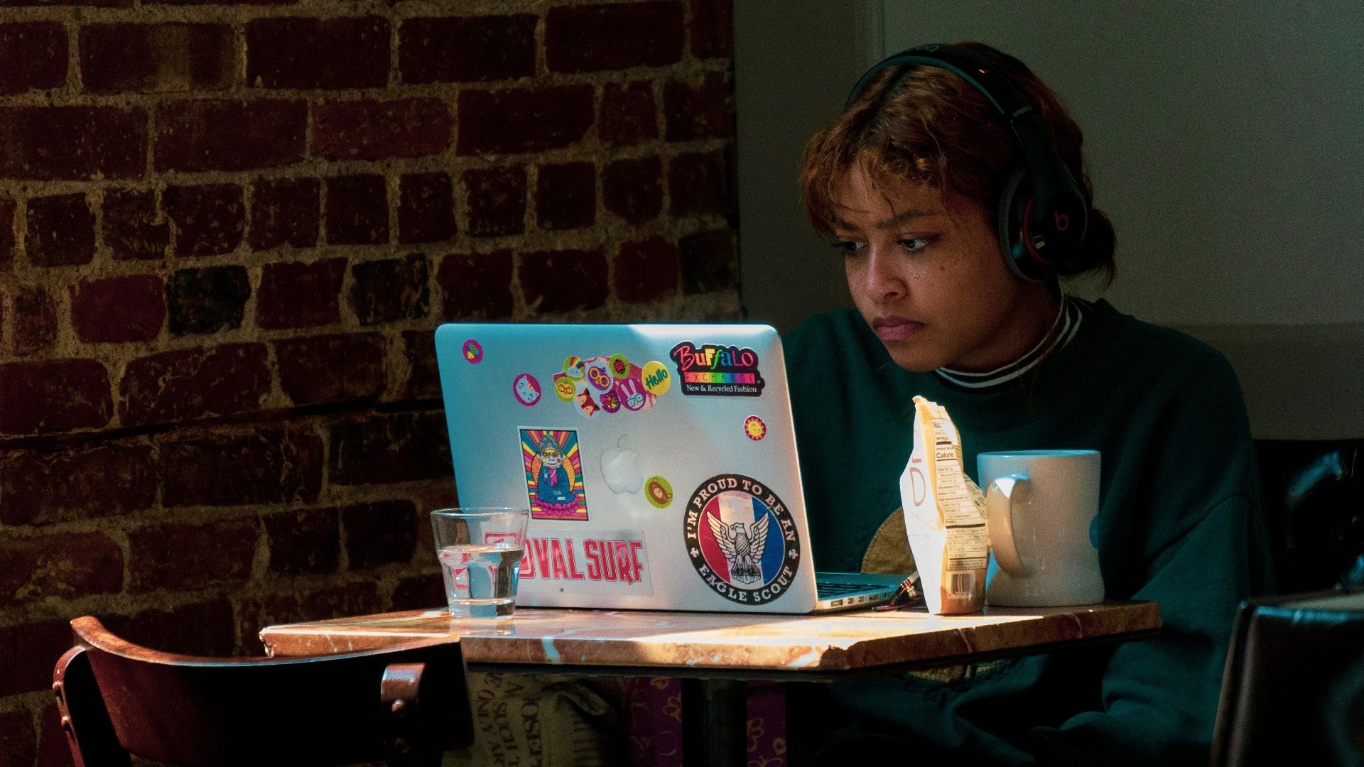a woman sitting in front of a laptop computer