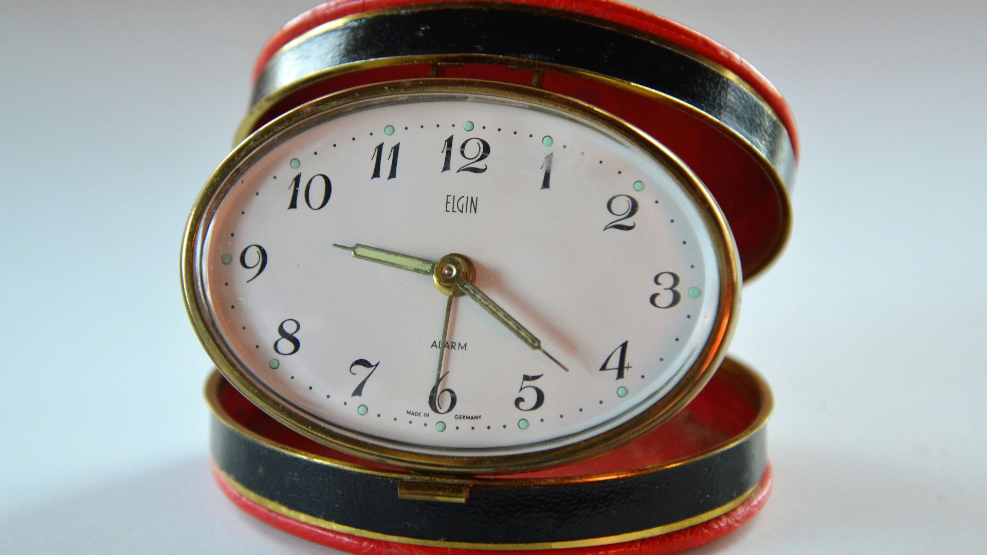 oval white and orange analog clock