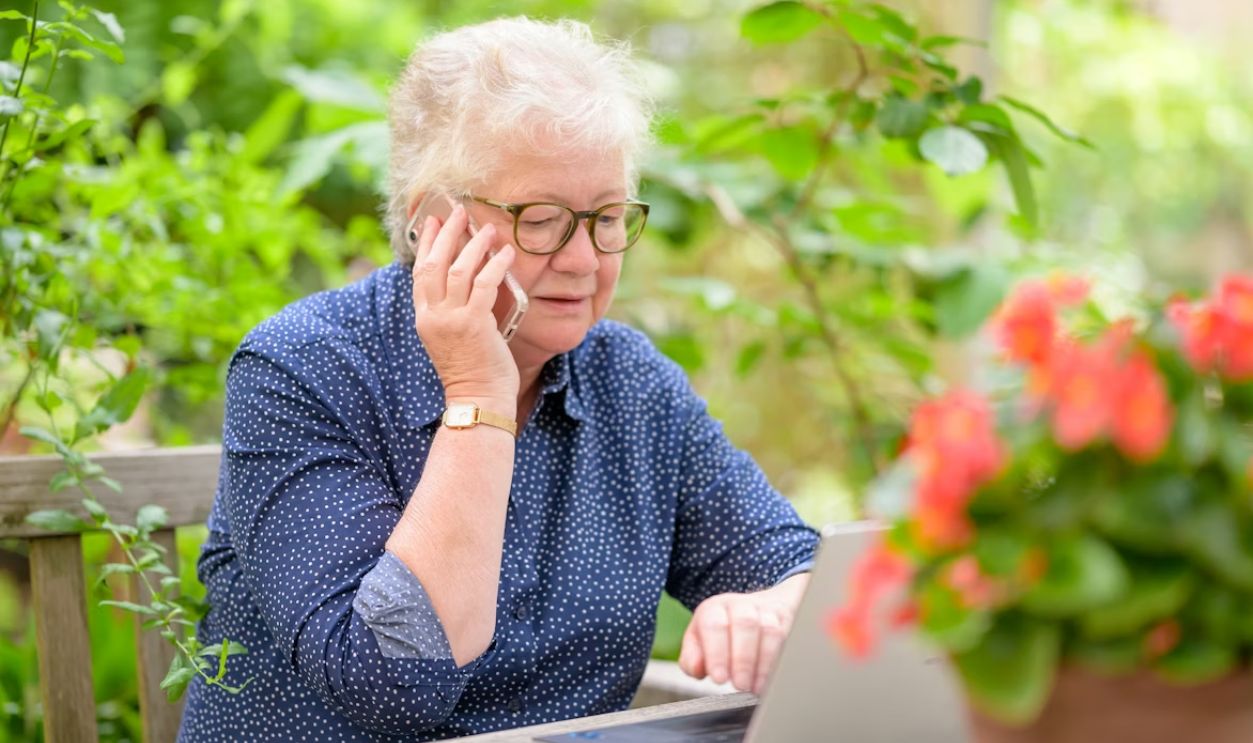 an old woman using a laptop