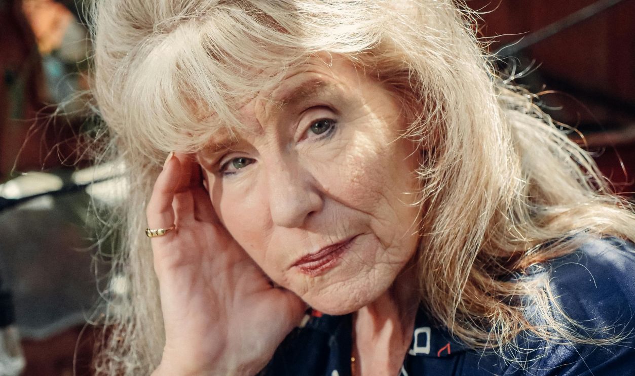 Portrait of a senior woman in blue, exuding thoughtful reflection and elegance