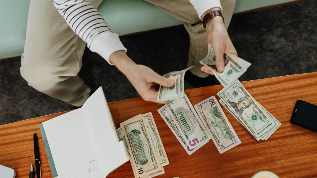 A Person Holding Bank Notes