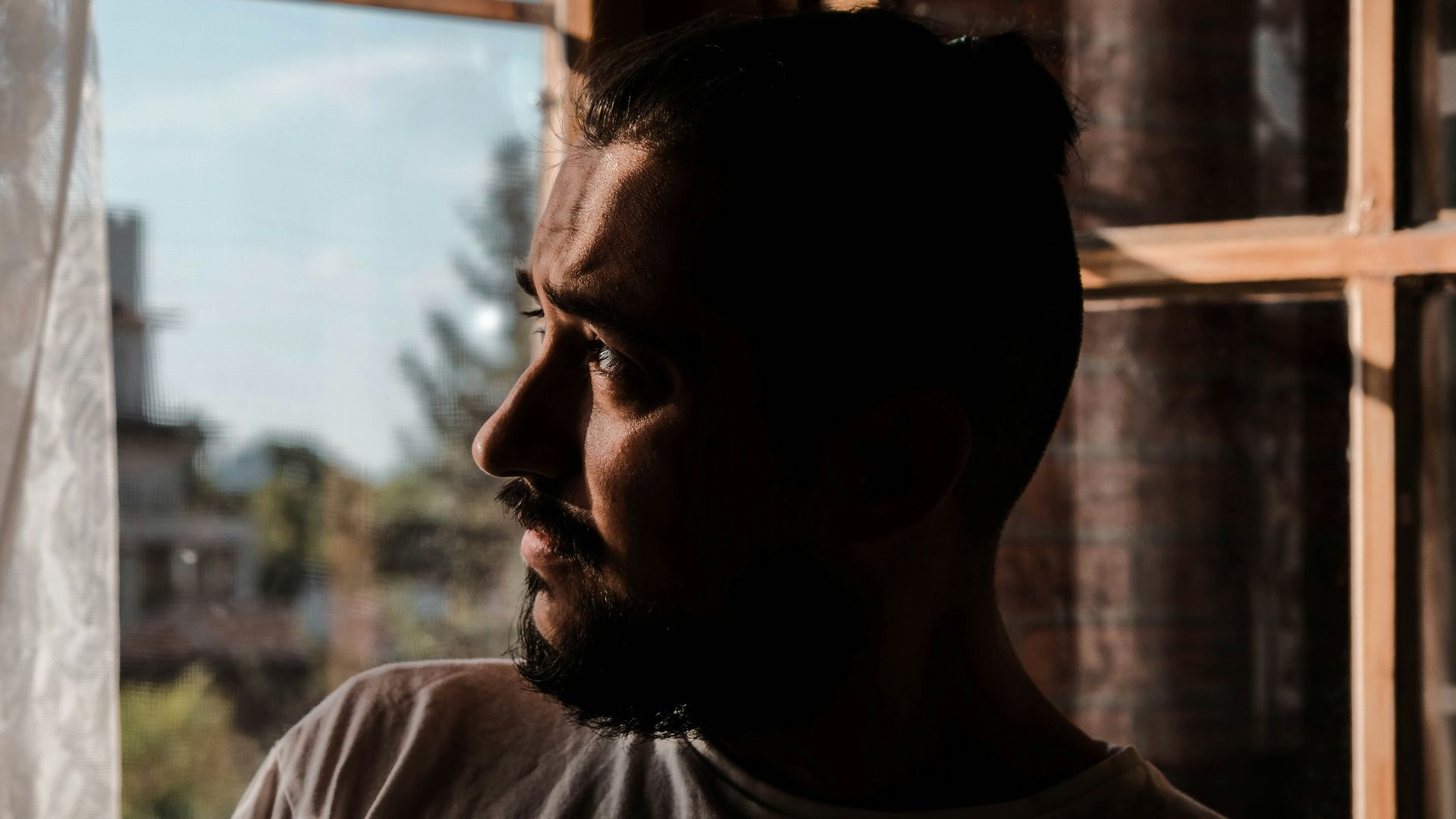 a man looking out of a window in a building