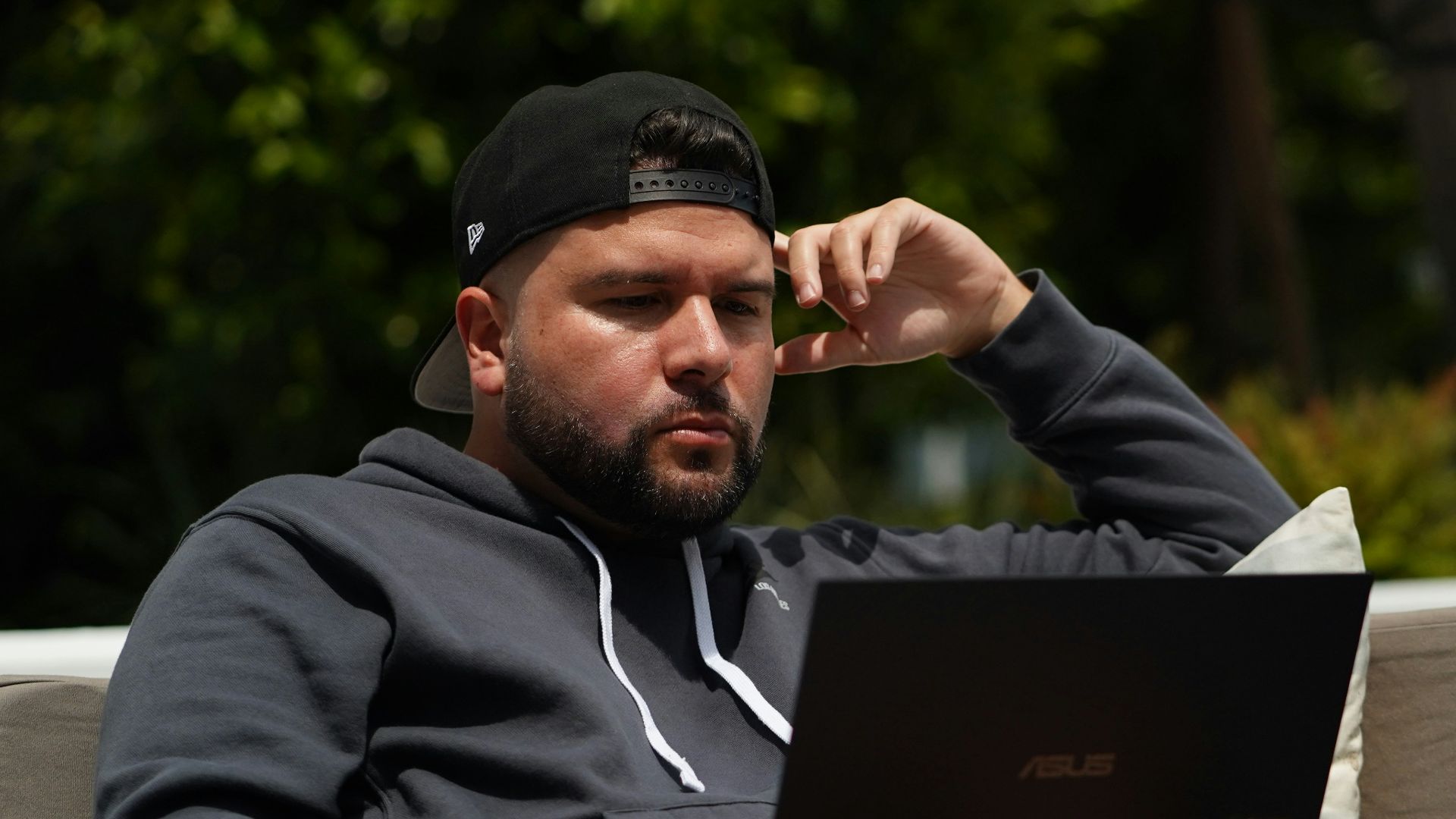 man in black hoodie using black laptop computer