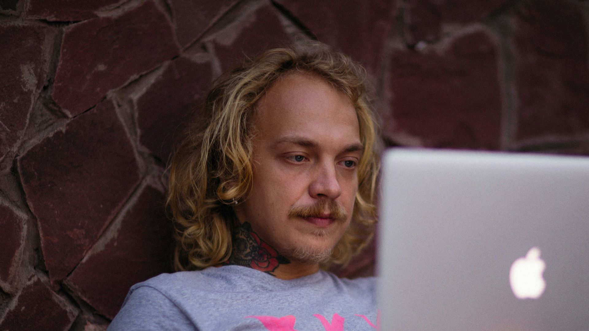 a person sitting on a couch with a laptop