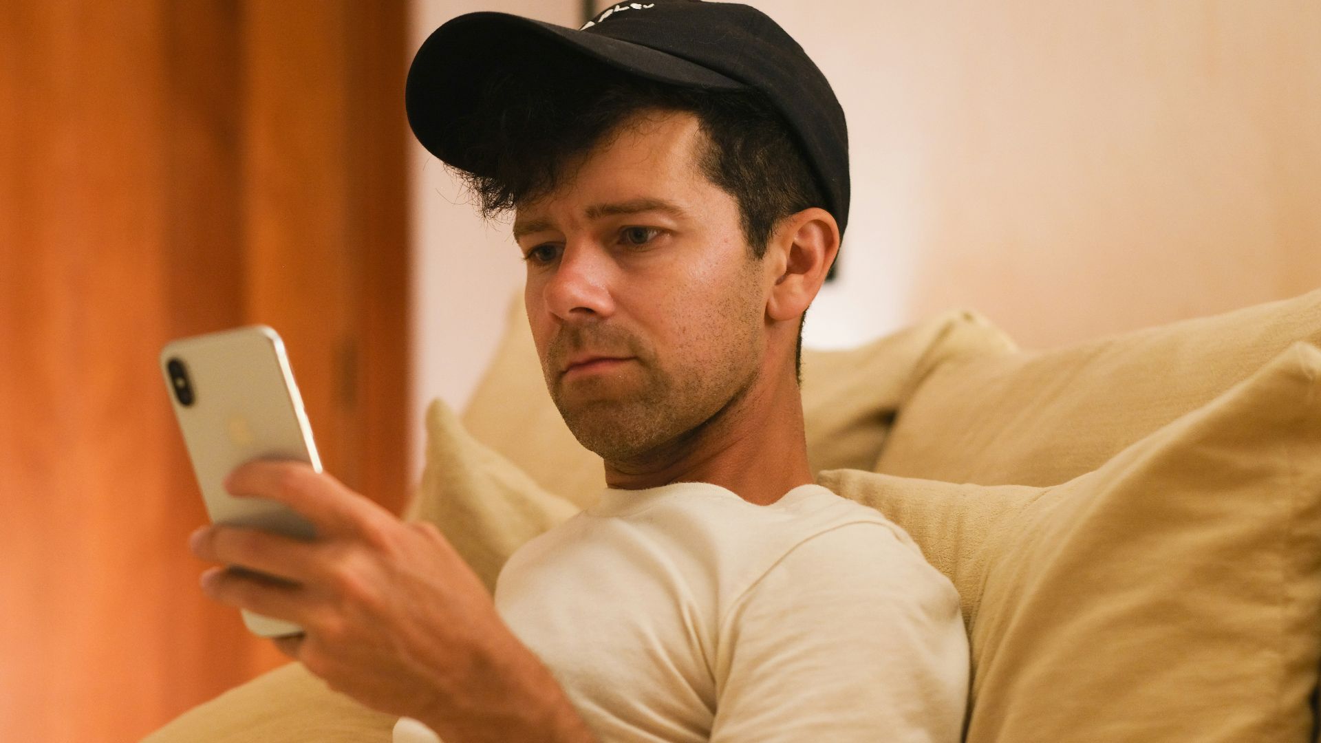 A man is focused on his phone.