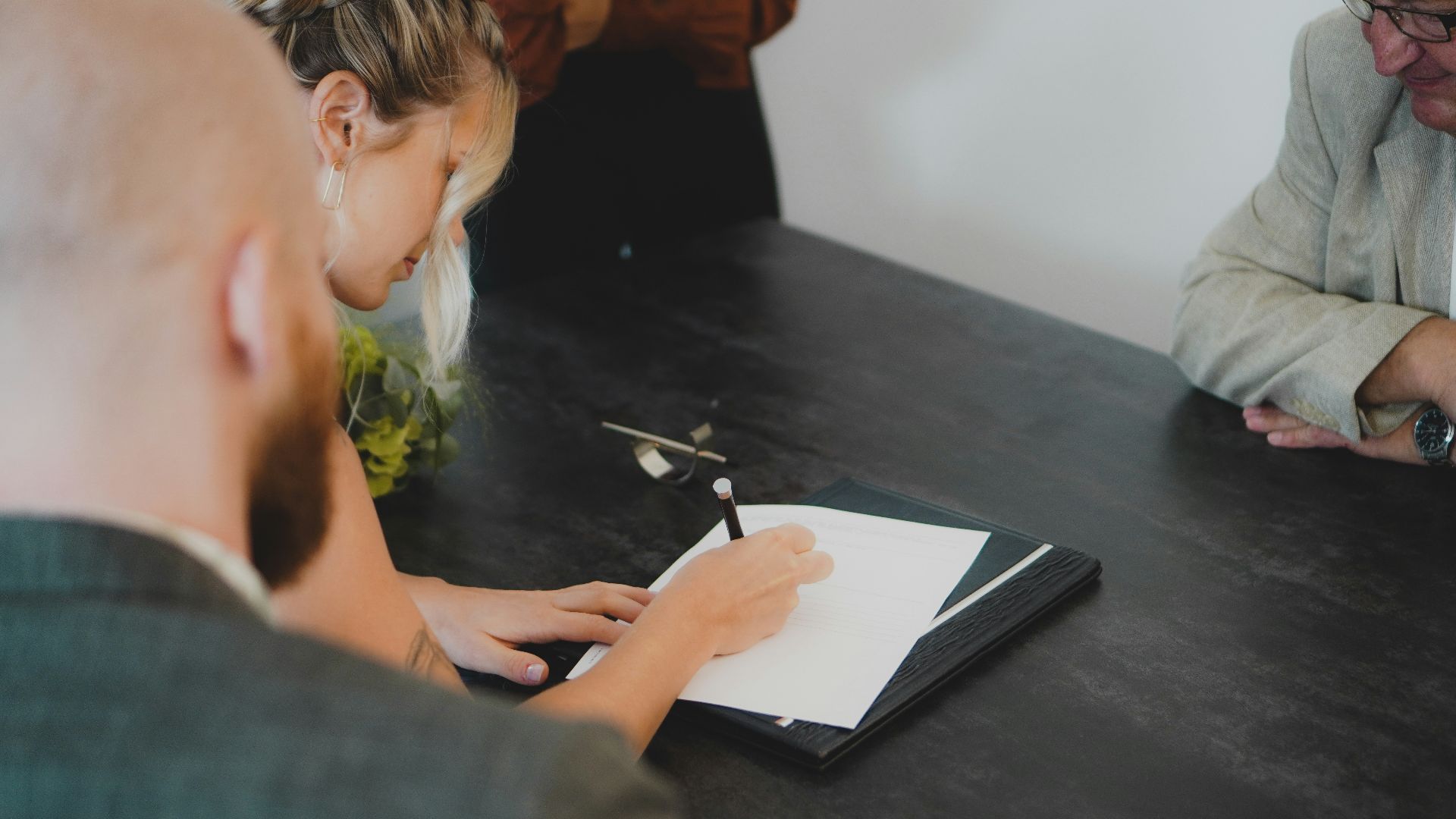 a man writing on a piece of paper