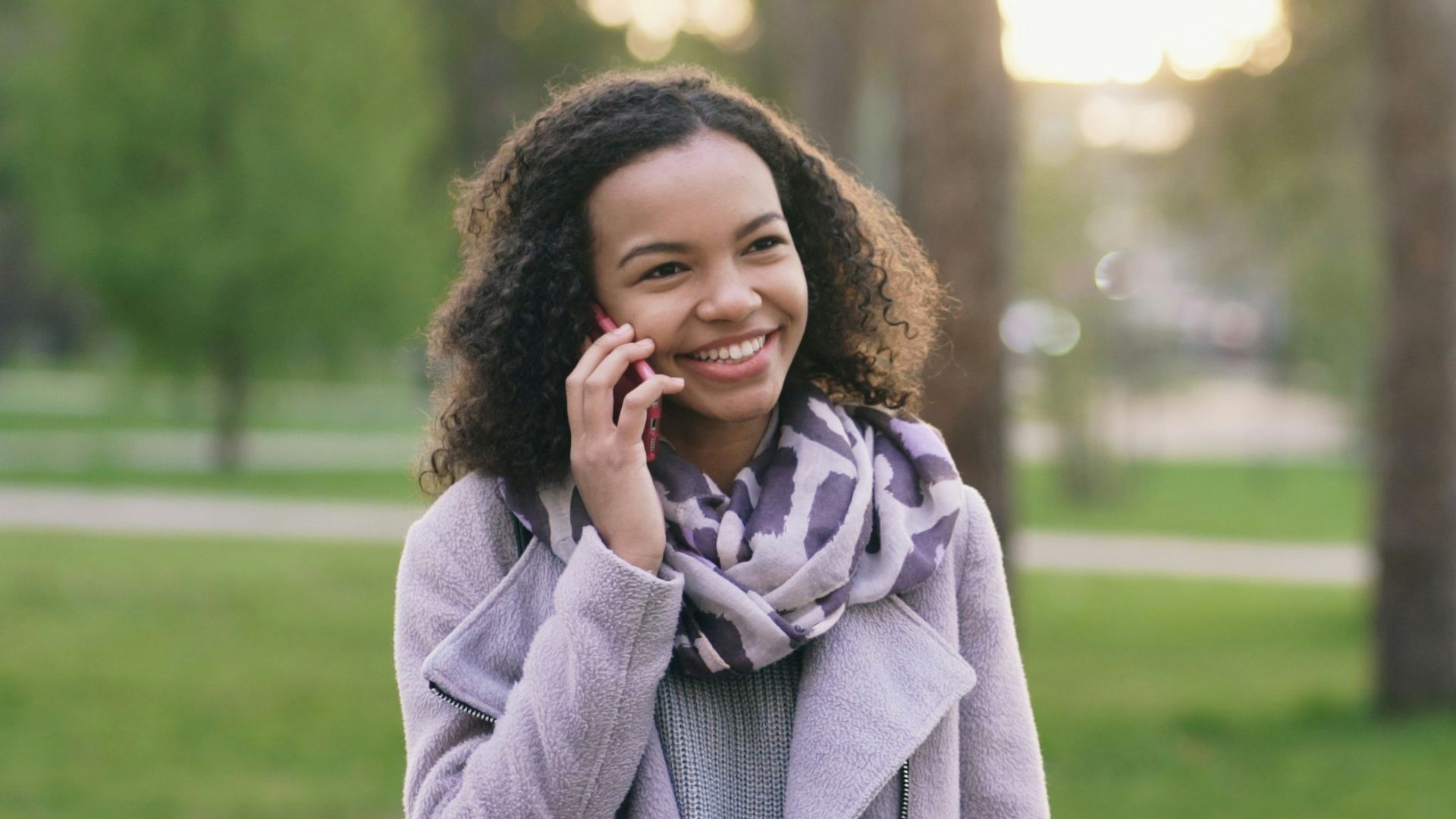 Woman talking on phone in a park