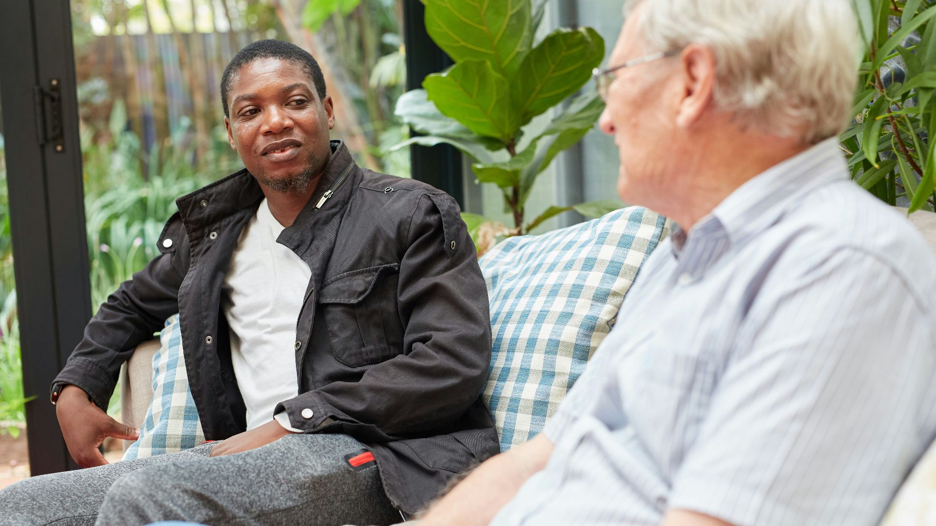 a couple of people sitting on top of a couch
