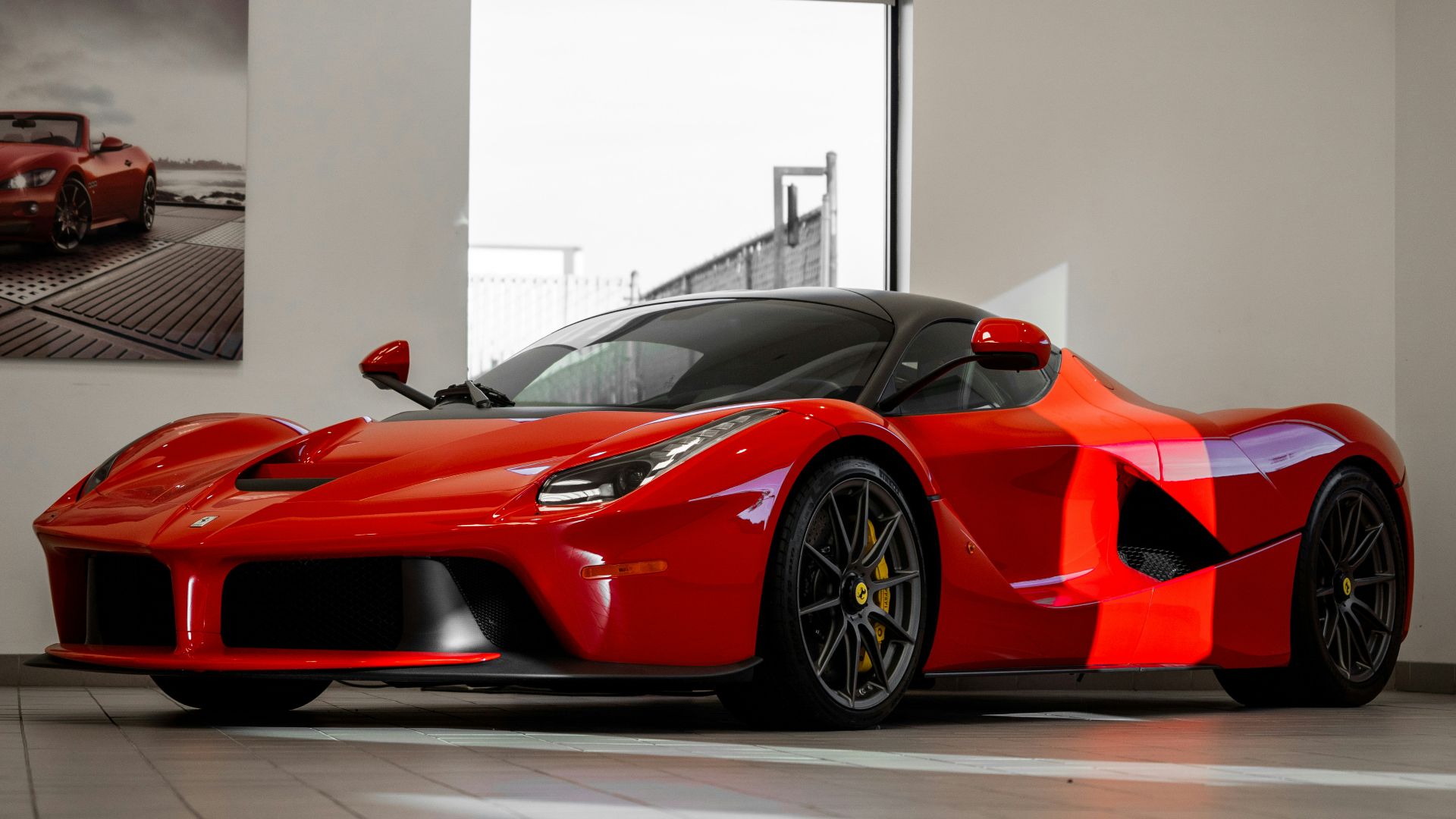 red ferrari 458 italia parked in front of white wall