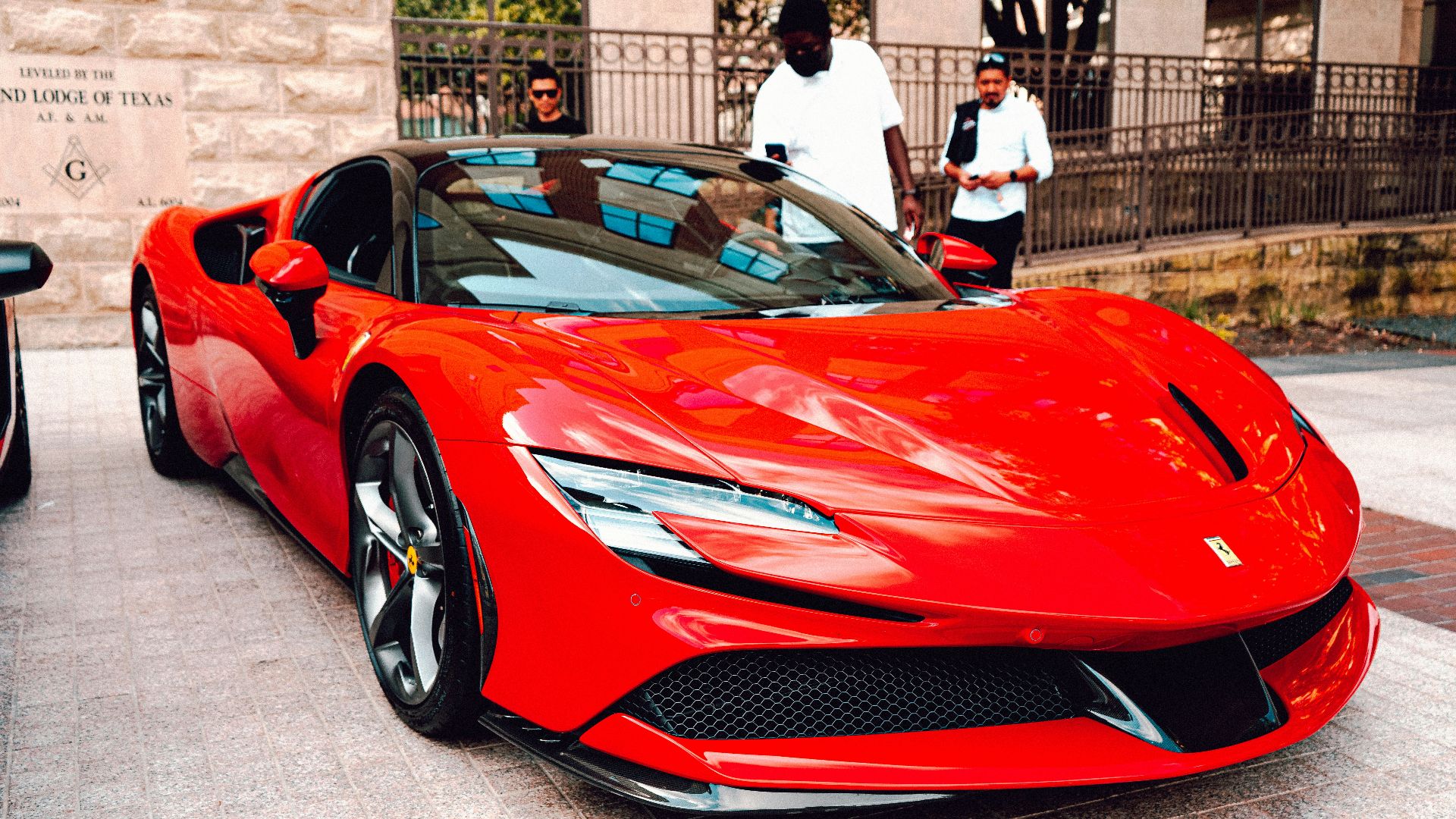 a red sports car parked in front of a building