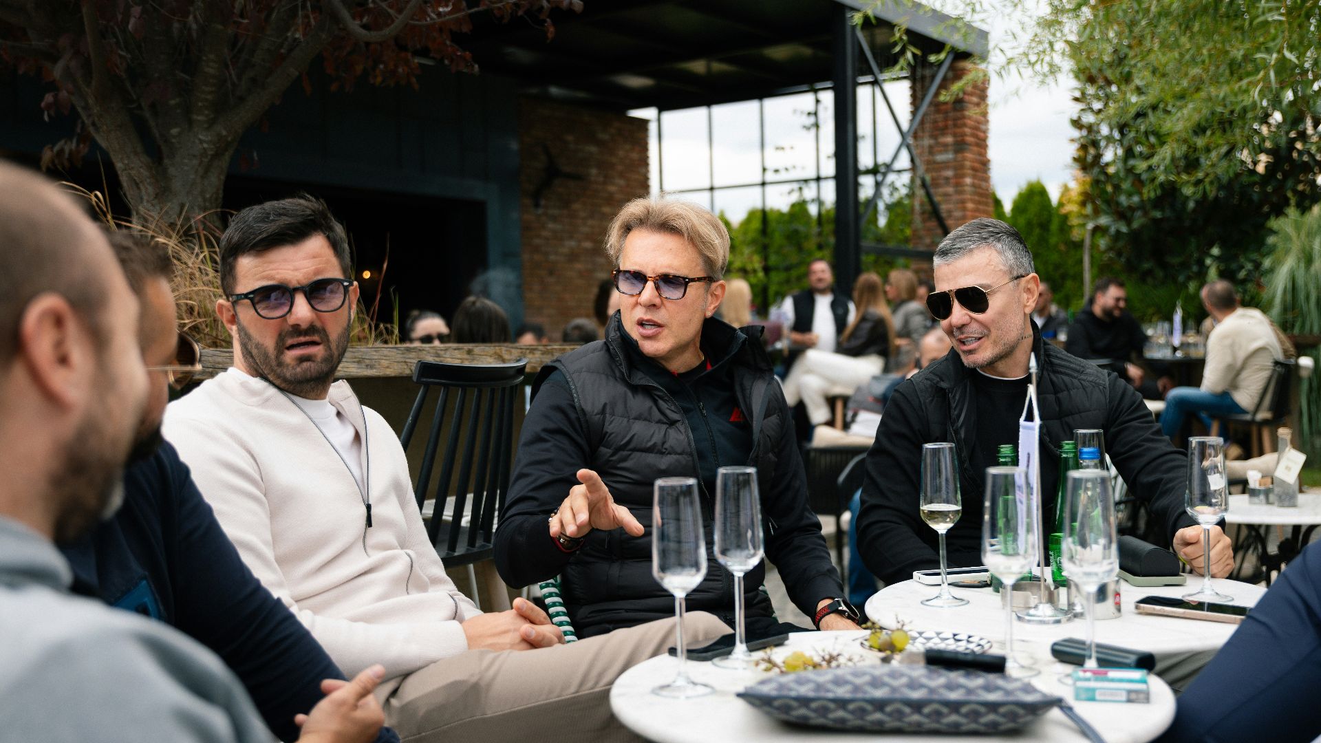 Group of people sitting at an outdoor cafe