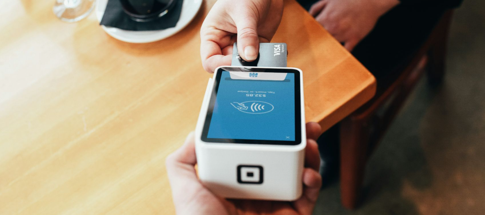 person holding credit card swipe machine