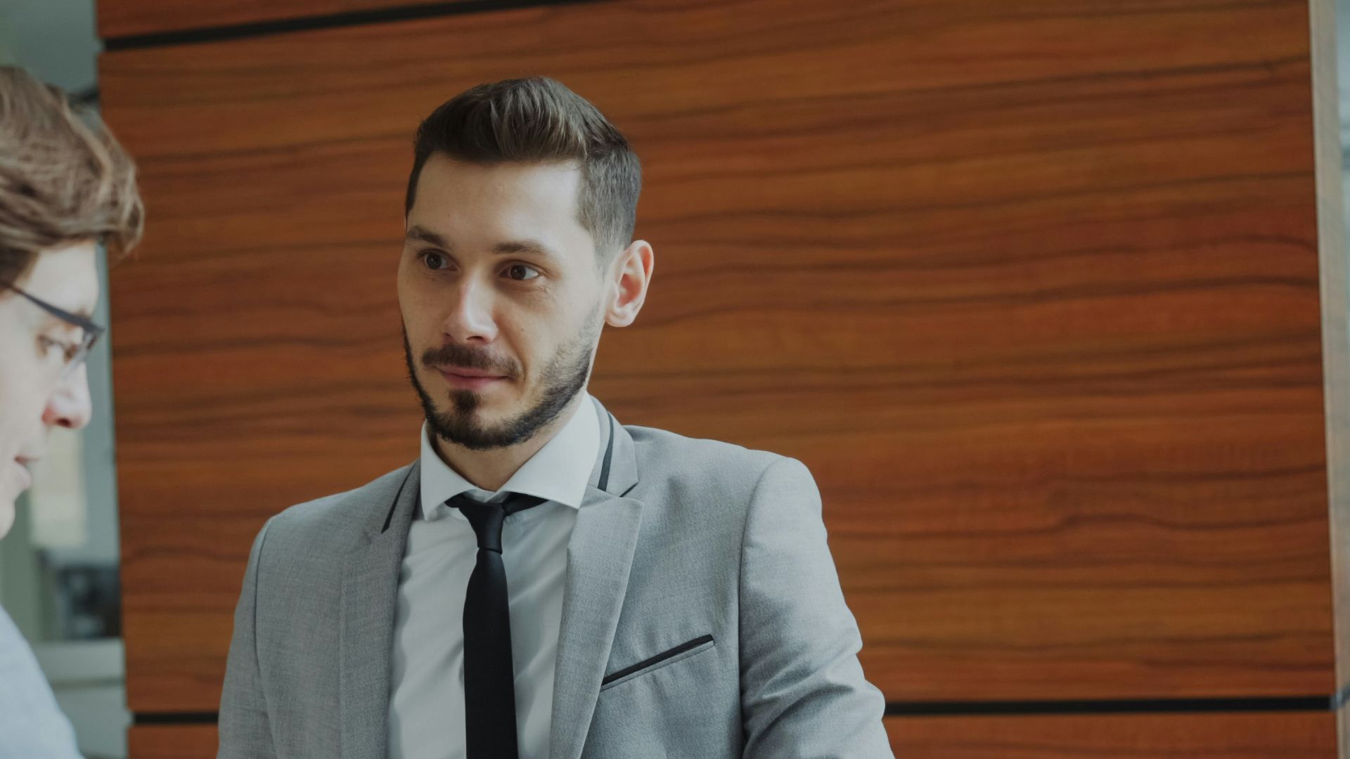 Two businessmen shaking hands in modern office