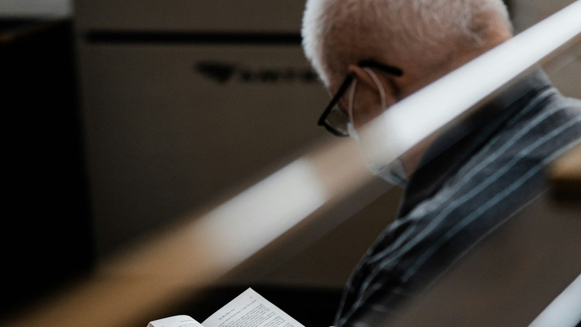 man in black leather jacket reading book