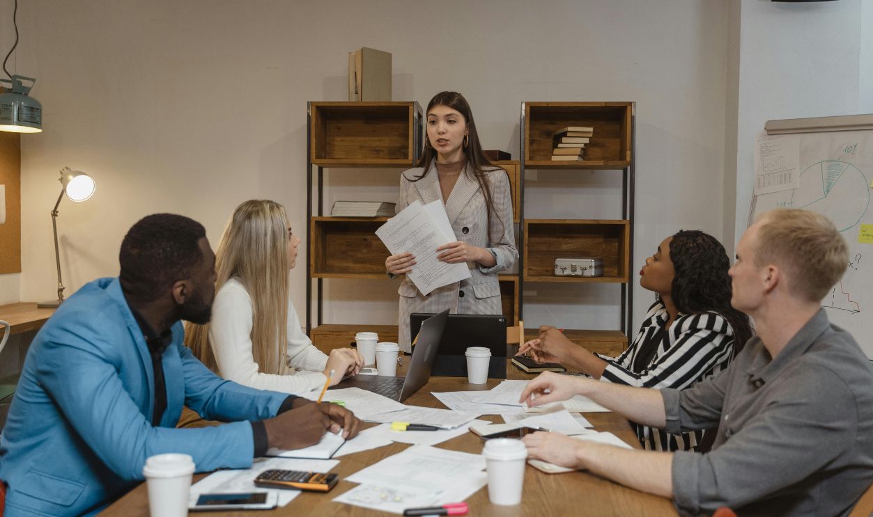 A diverse team of professionals in a creative office engaged in a collaborative business meeting