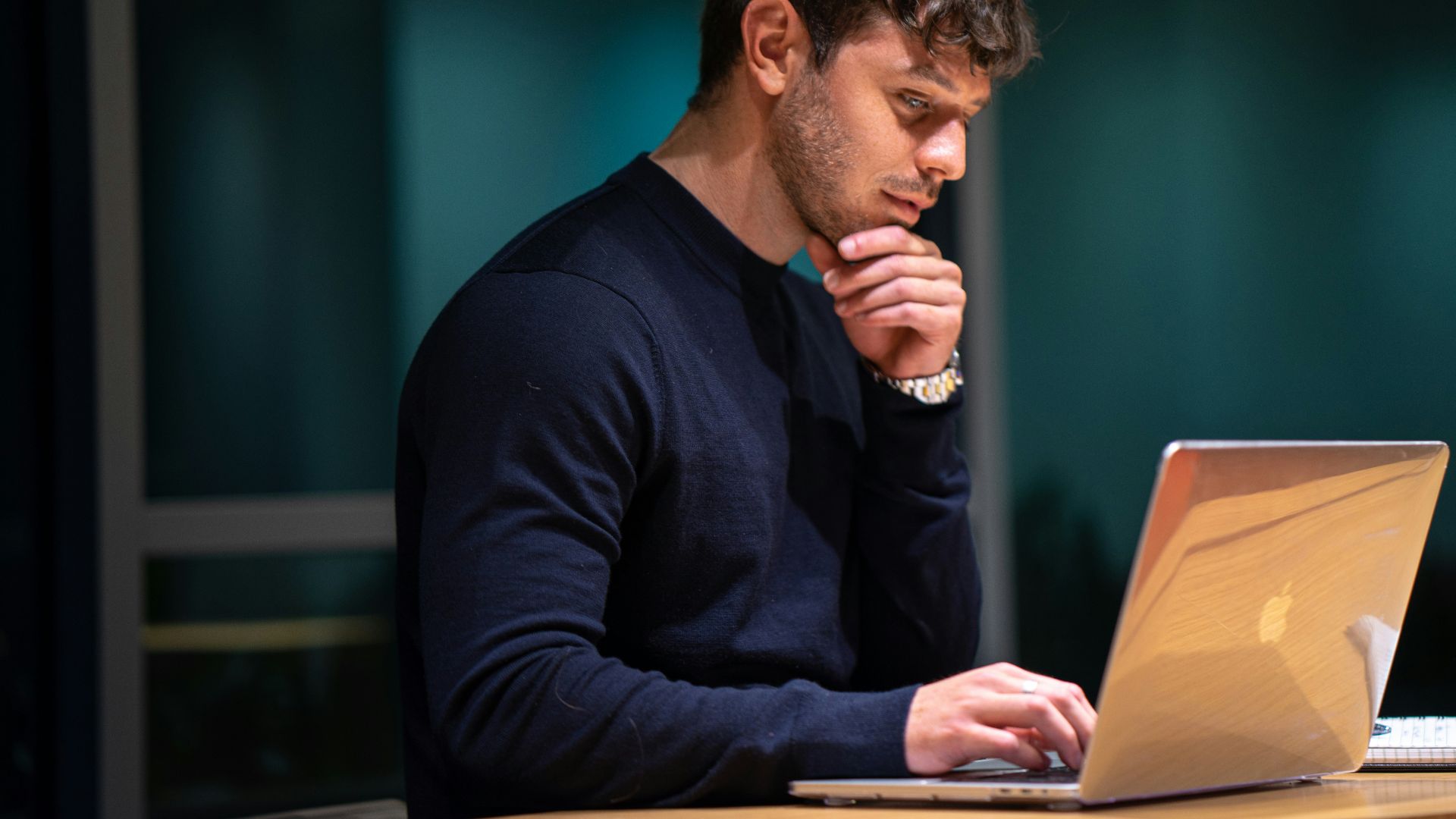 man in black long sleeve shirt sitting in front of macbook